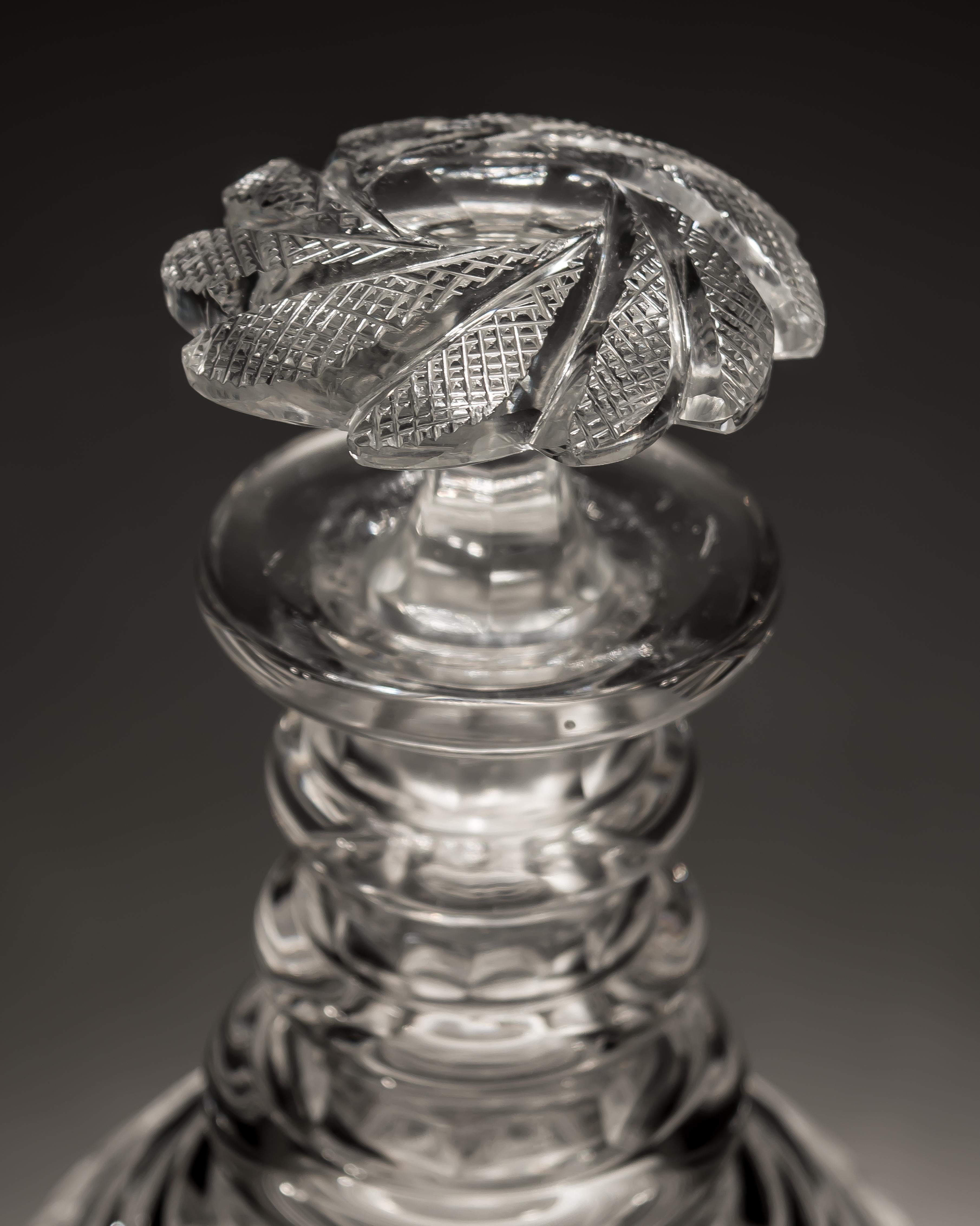 Exceptional pair of swirl cut Regency decanters with swirl cut stoppers.