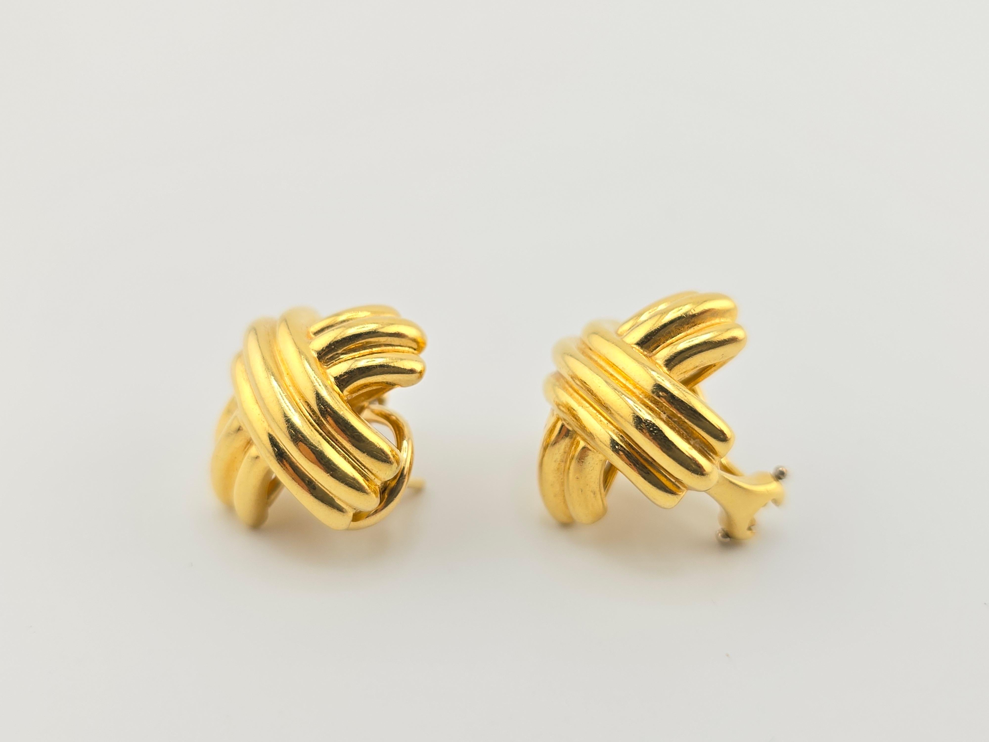 This is a gorgeous pair of Tiffany & Co. 18 Karat Yellow Gold X earrings. The condition on the earrings is great and it is ready to go. Each one is hallmarked by Tiffany & Co 18 karat. The size of each earring is 19 mm x 18 mm x 14 mm. The weight