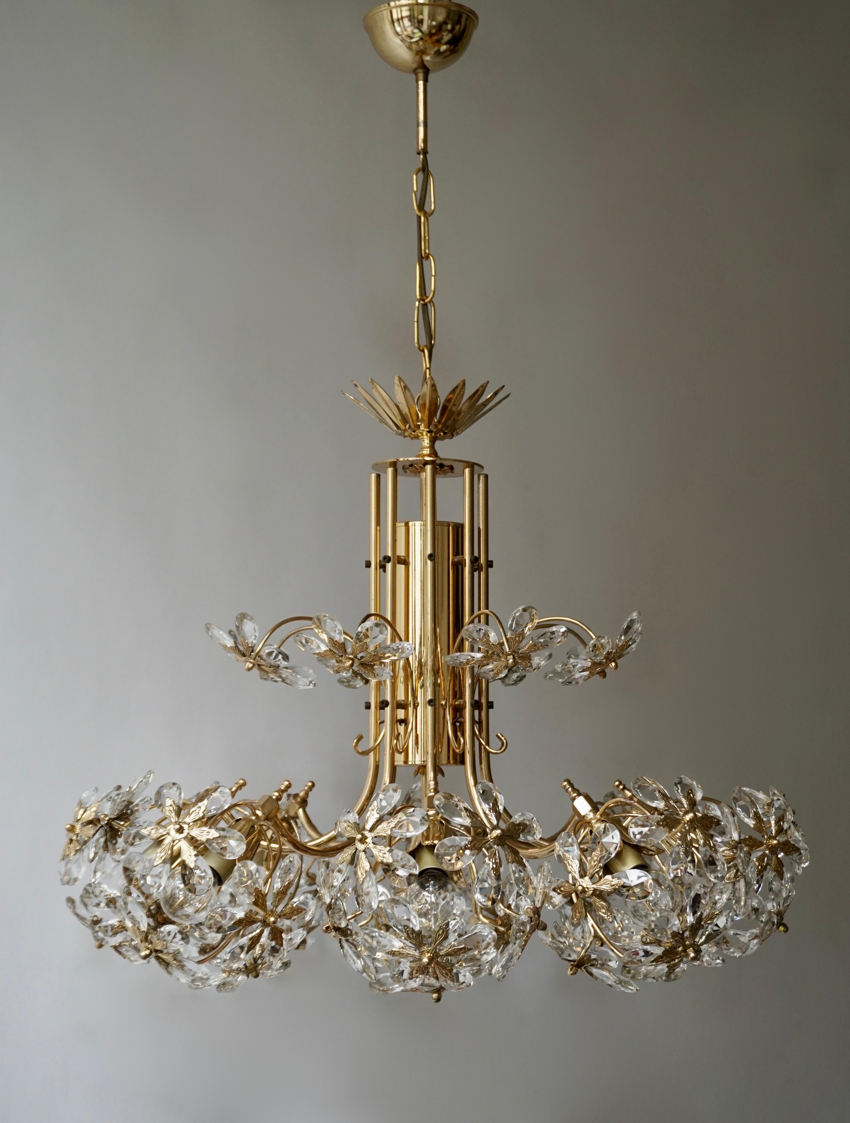 Beautiful petite crystal flower ball chandelier made by Palwa, Germany, circa 1960-1970. The chain-hanging length-adjustable chandelier has a delicate gilt metal wire construction, on top with 62 beautiful hand-cut faceted crystals in the shape of