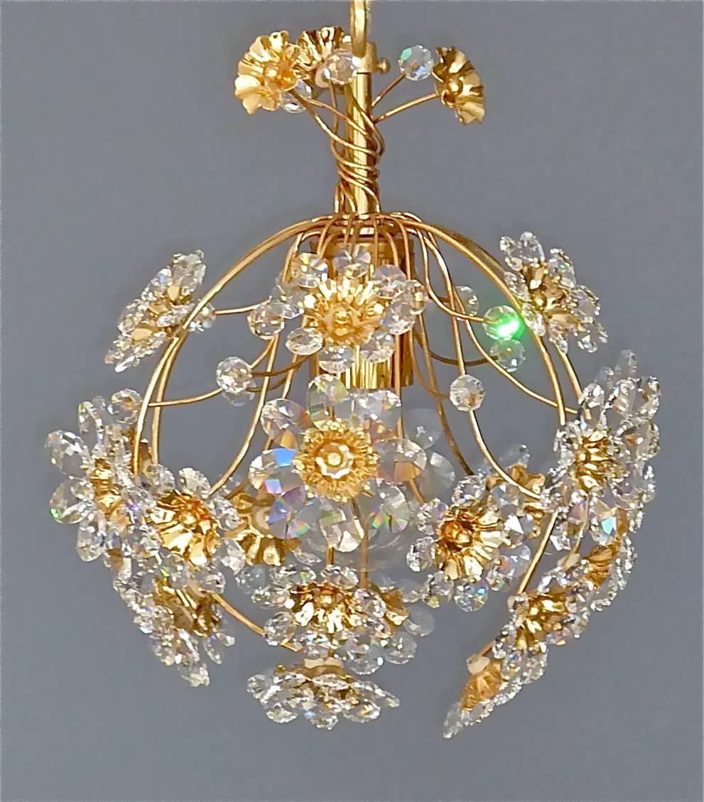 Beautiful petite crystal flower ball chandelier made by Palwa, Germany, circa 1960-1970. The chain-hanging length-adjustable chandelier has a delicate gilt metal wire construction forming a ball, on top with beautiful hand-cut faceted crystals in