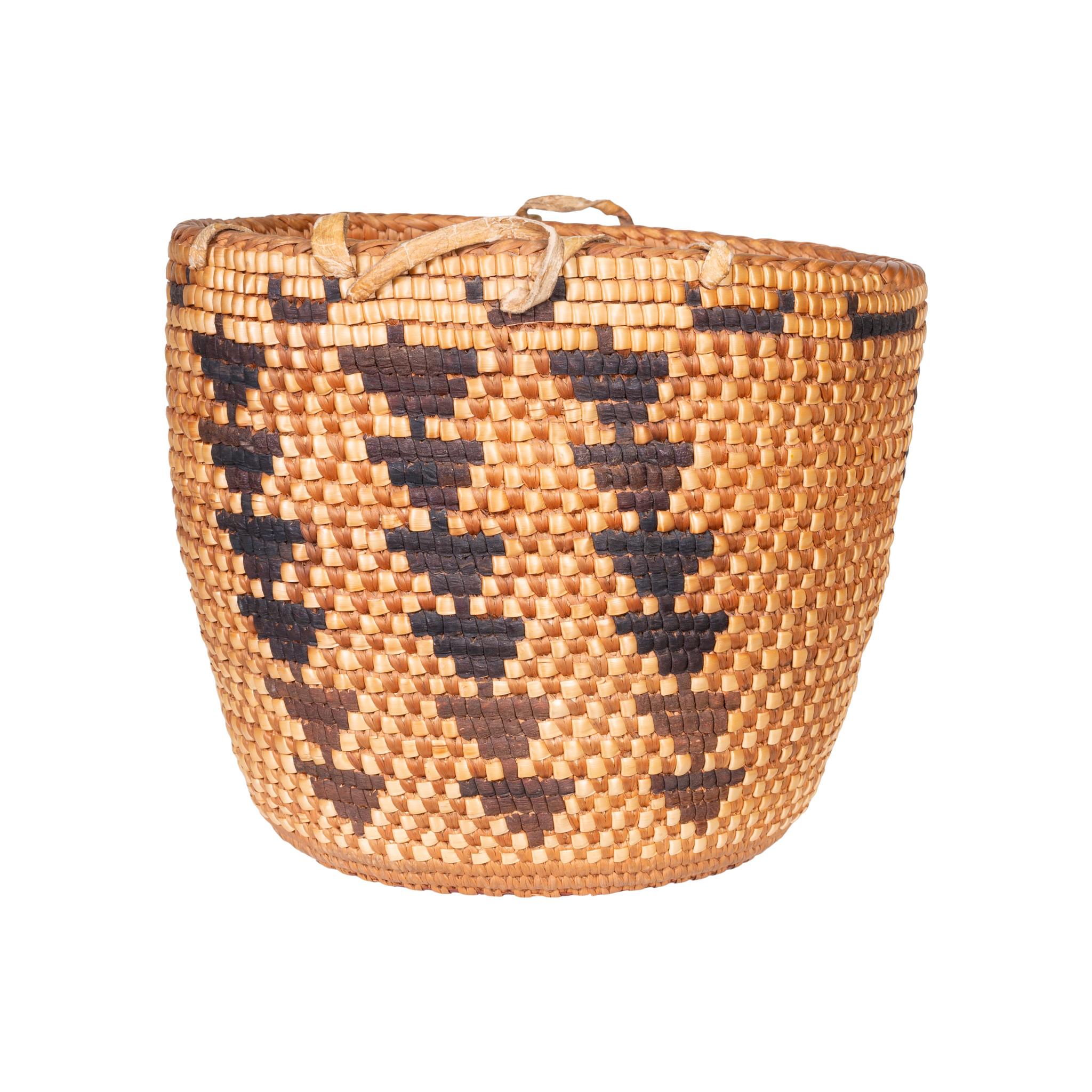 Stunning Klickitat/Snoquamie basket with imbrication featuring vertical rows of downward pointing stacked triangles. Original hide belt loops. You will not be disappointed in this purchase! 7 1/2