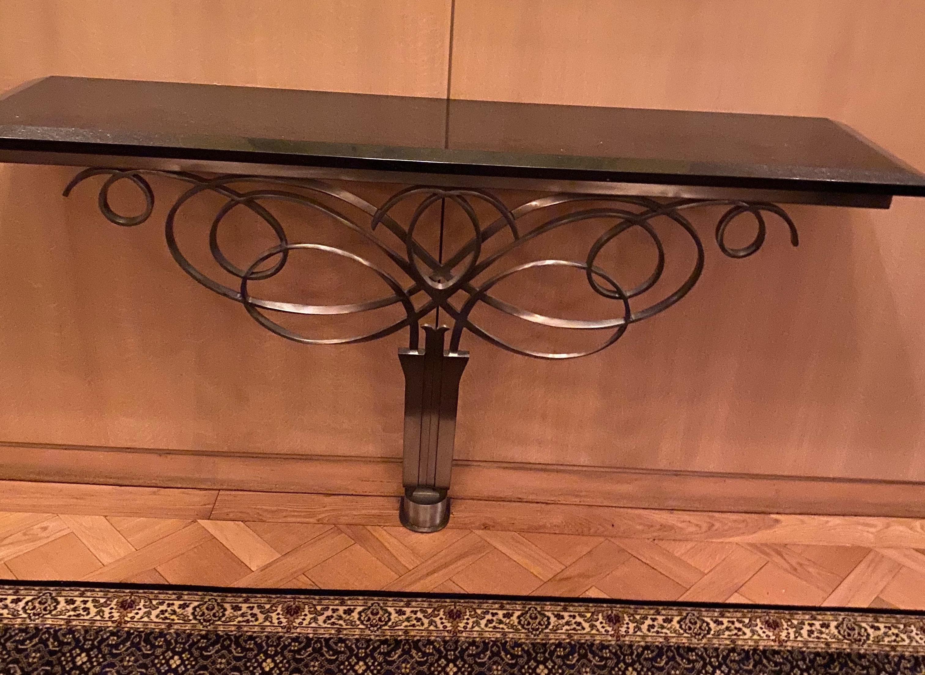Exceptional pair of solid stainless and marble console tables in the style of Leleu. Custom made for the lobby of one Chicago's most prominent restaurants. Wall mount with base support. Priced per console table.