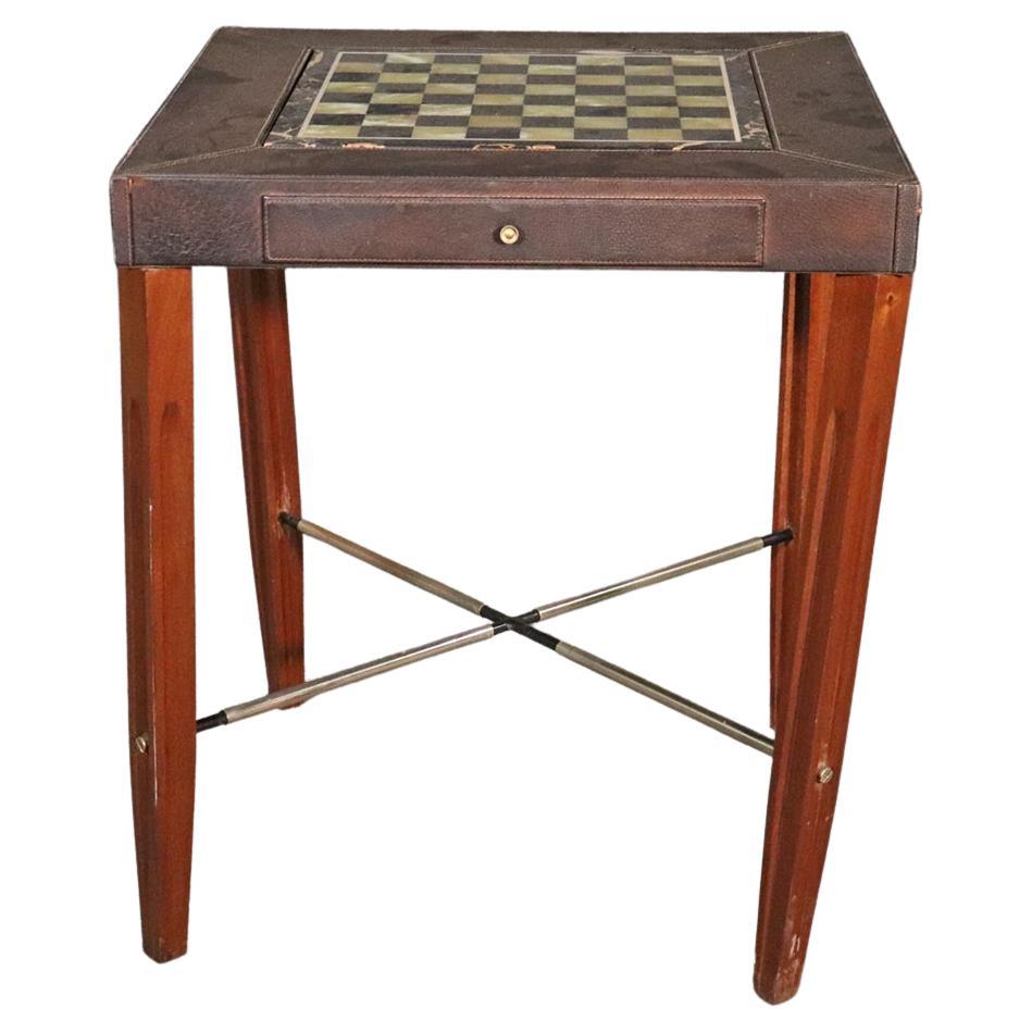 This is a fantastic green and black onyx top Aldo Tura style games table with gorgeous heavy playing pieces and leather wrapped surfaces. The table consists of a Chess board top. Leather. 2 drawers containing chess pieces. Measures: Metal x base.