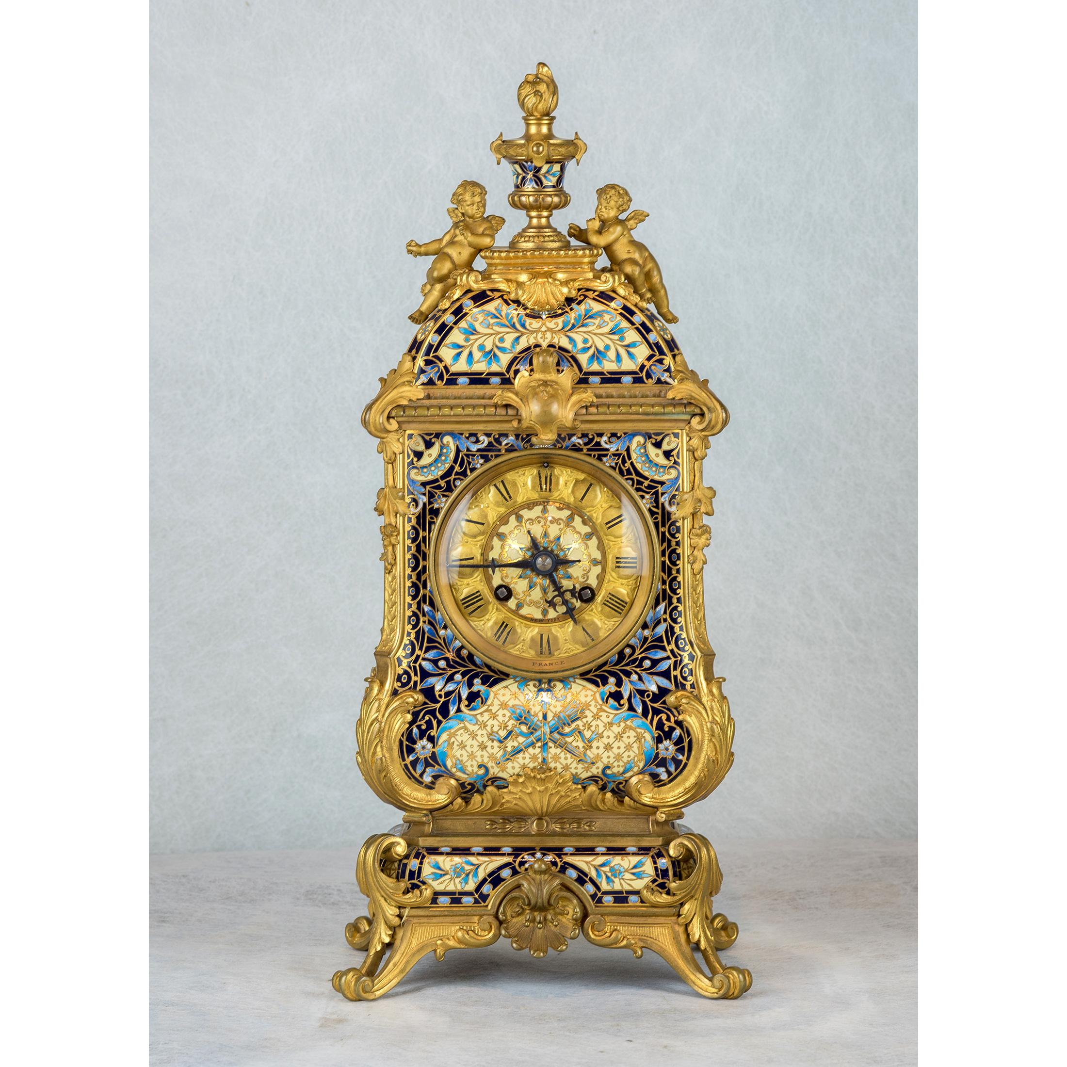 Exceptional quality bronze mounted champlevé enamel three-piece clock garniture in the Moorish style, retailed by Tiffany & Co., NY.
Comprising a clock marked 'Tiffany & Co.' on face and on back of movement, and a pair of five-light candelabra.