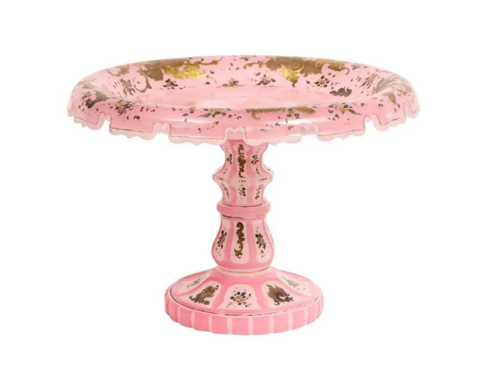 Exceptional Quality Pink Triple Overlay Enameled Bohemian Glass Cake Stand Centerpiece, 19th century.

Made for the Ottoman Islamic market.

Fantastic detailing throughout, enameled with flowers.

9″ high x 13″ diameter

Excellent condition