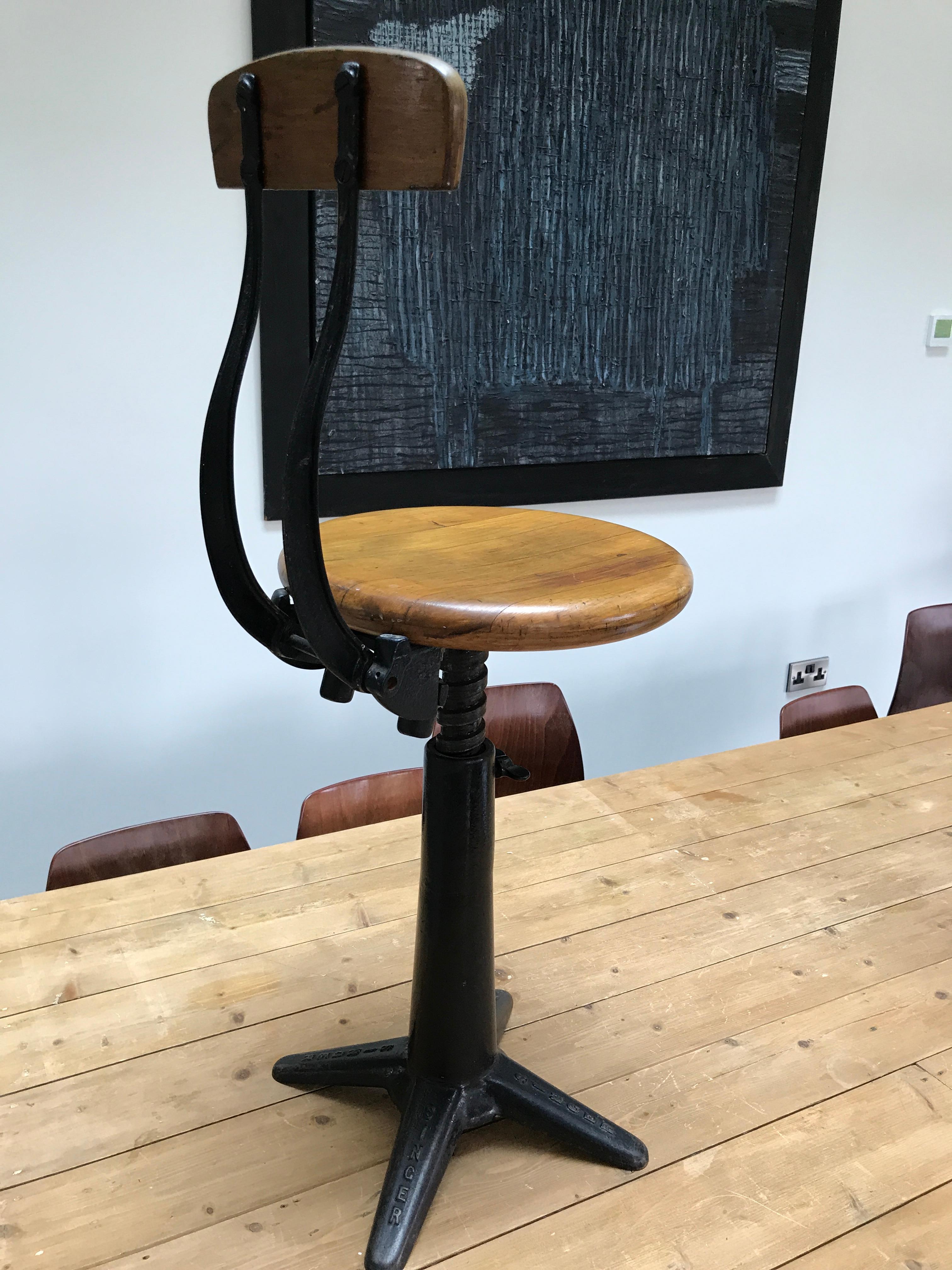 Exceptional quality cast iron Singer industrial stool with back rest original condition

Fully height adjustable, seat between 45 and 64cm (18-25.5 inch) the backrest is sprung by two springs

Measurements are Seat height between 45-64cm,