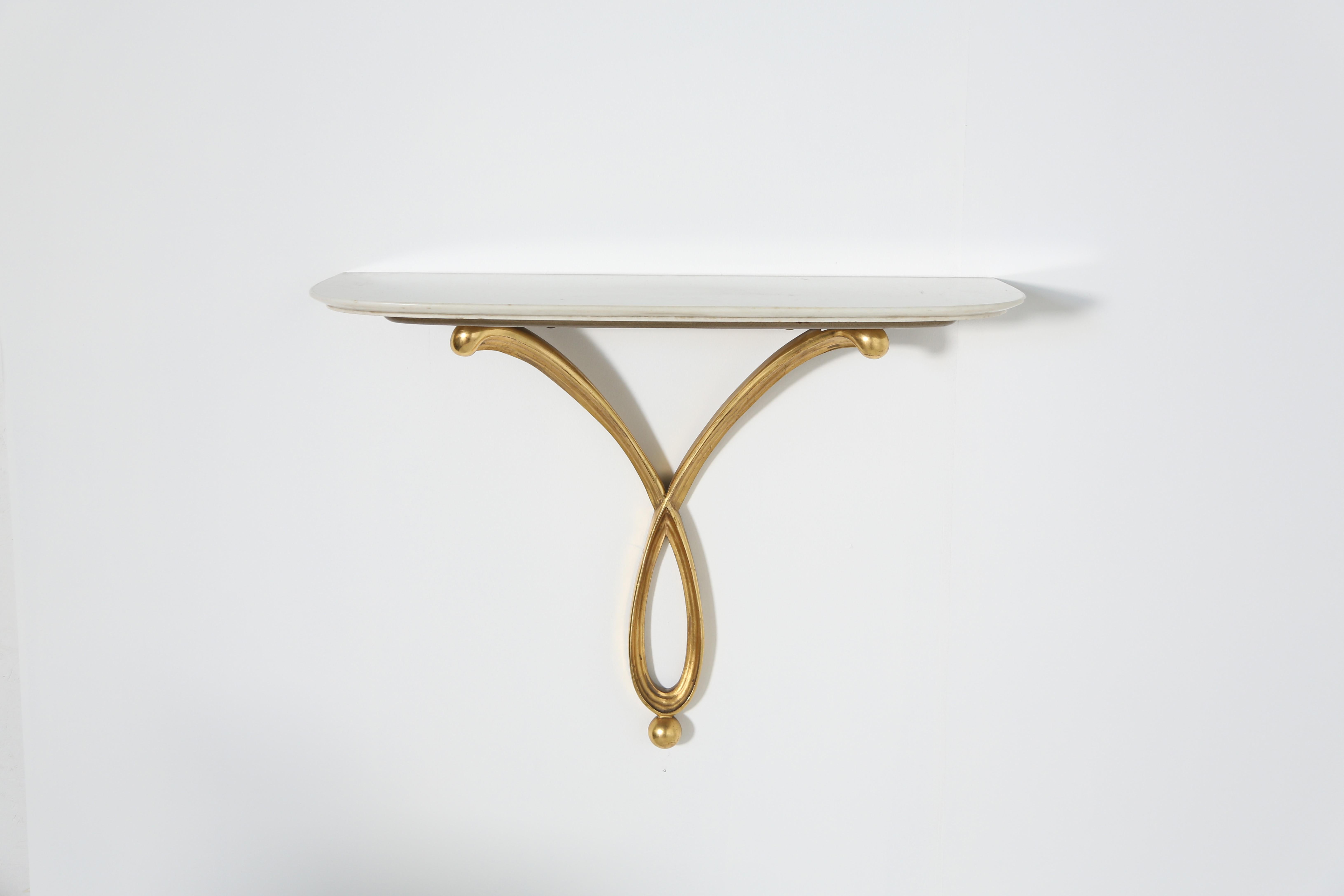 An exceptional wall-mounted console by Osvaldo Borsani, Italy, 1940s. Maple wood, gilded wood and marble, with wall bracket.  Produced by Atalier Borsani Varedo.  Some signs of age and use and restorations.   Fast shipping worldwide.
 
65 x 85 x