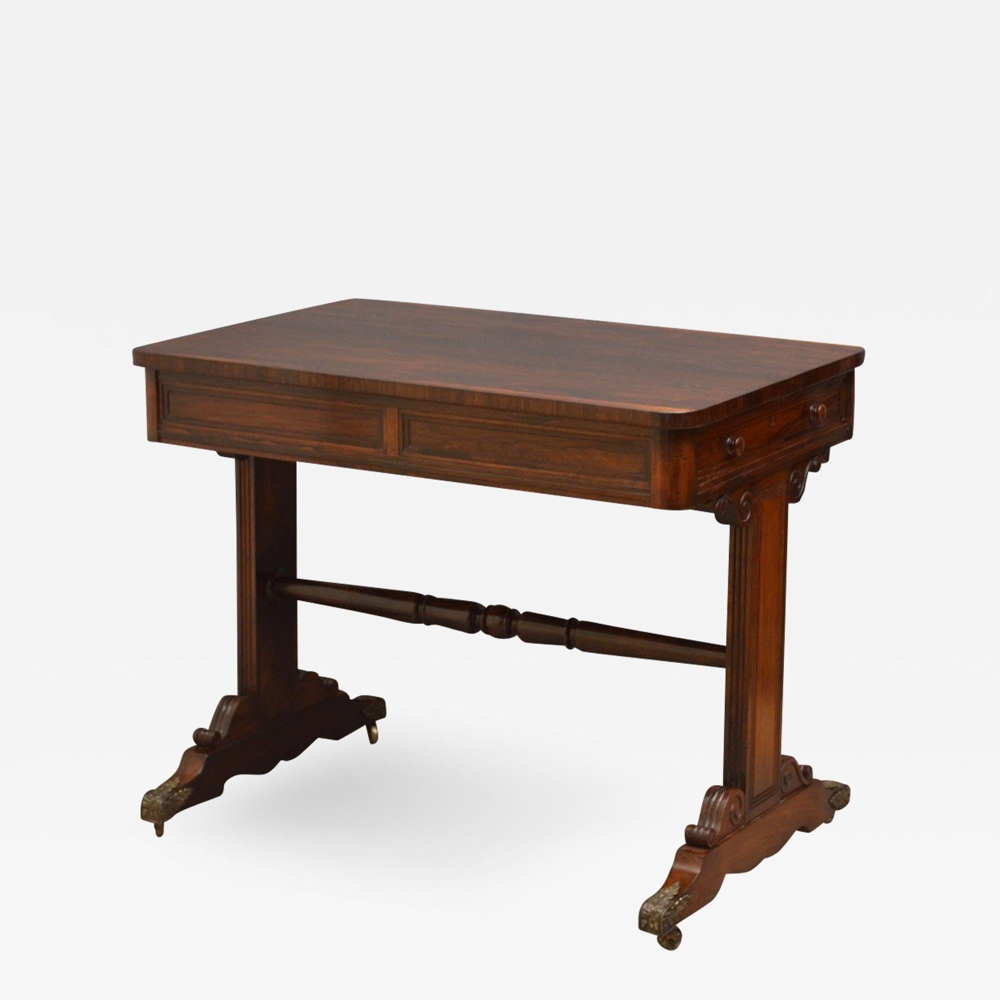 Sn4466 Elegant Regency library table of small proportions, having attractive rosewood top with rounded corners above a panelled frieze and 2 mahogany lined drawers to each end, standing on finely carved supports terminating in carved lags with brass