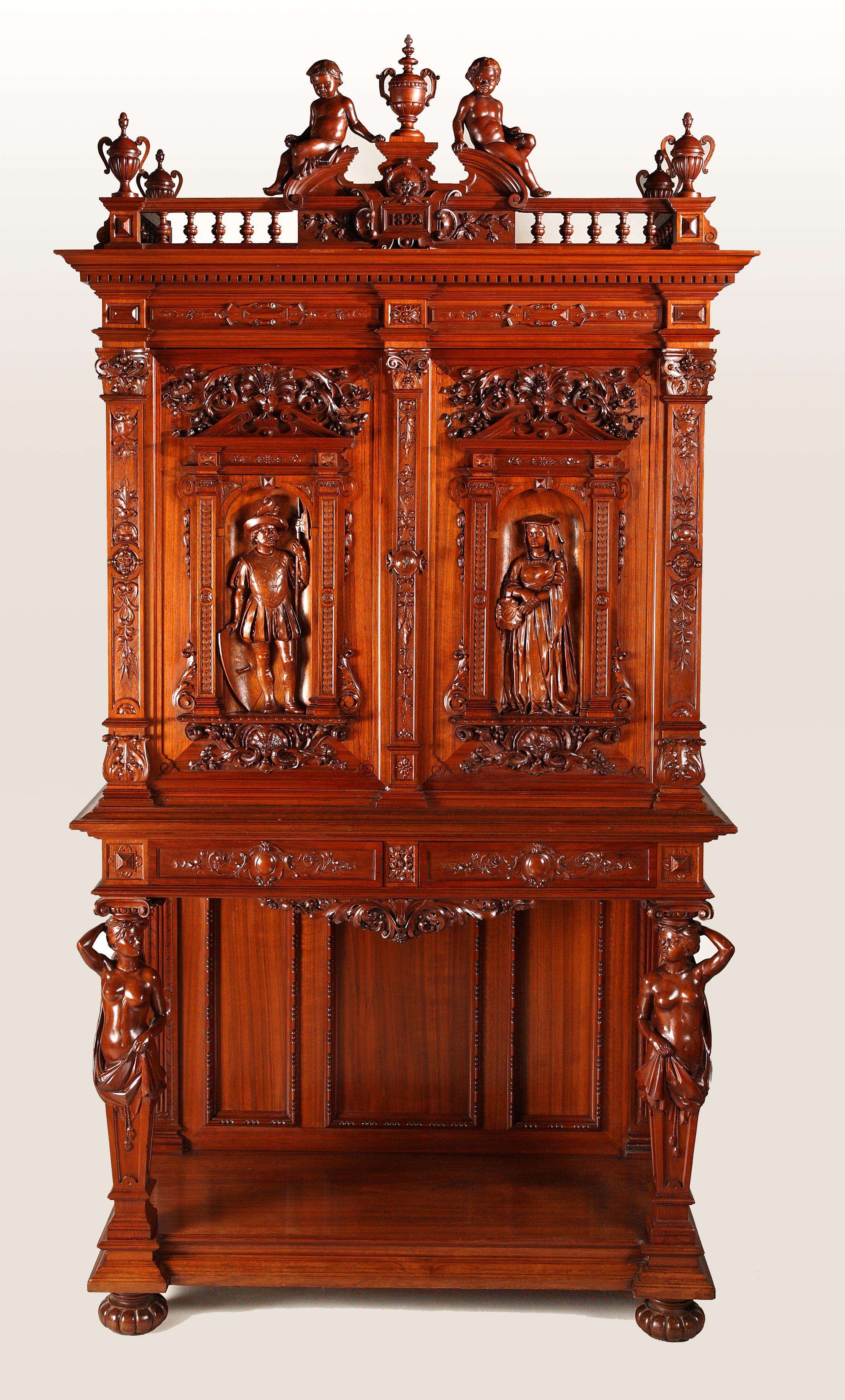 A wooden cupboard, elaborately carved throughout, dated 