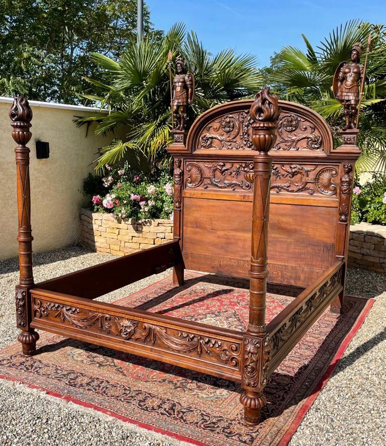 Superb castle bed in walnut entirely carved in the Renaissance style. This bed depicts Prometheus, God and Greek hero, stealing fire with the help of Athena, in order to offer it to humanity. The headboard and the footboard are quite representative
