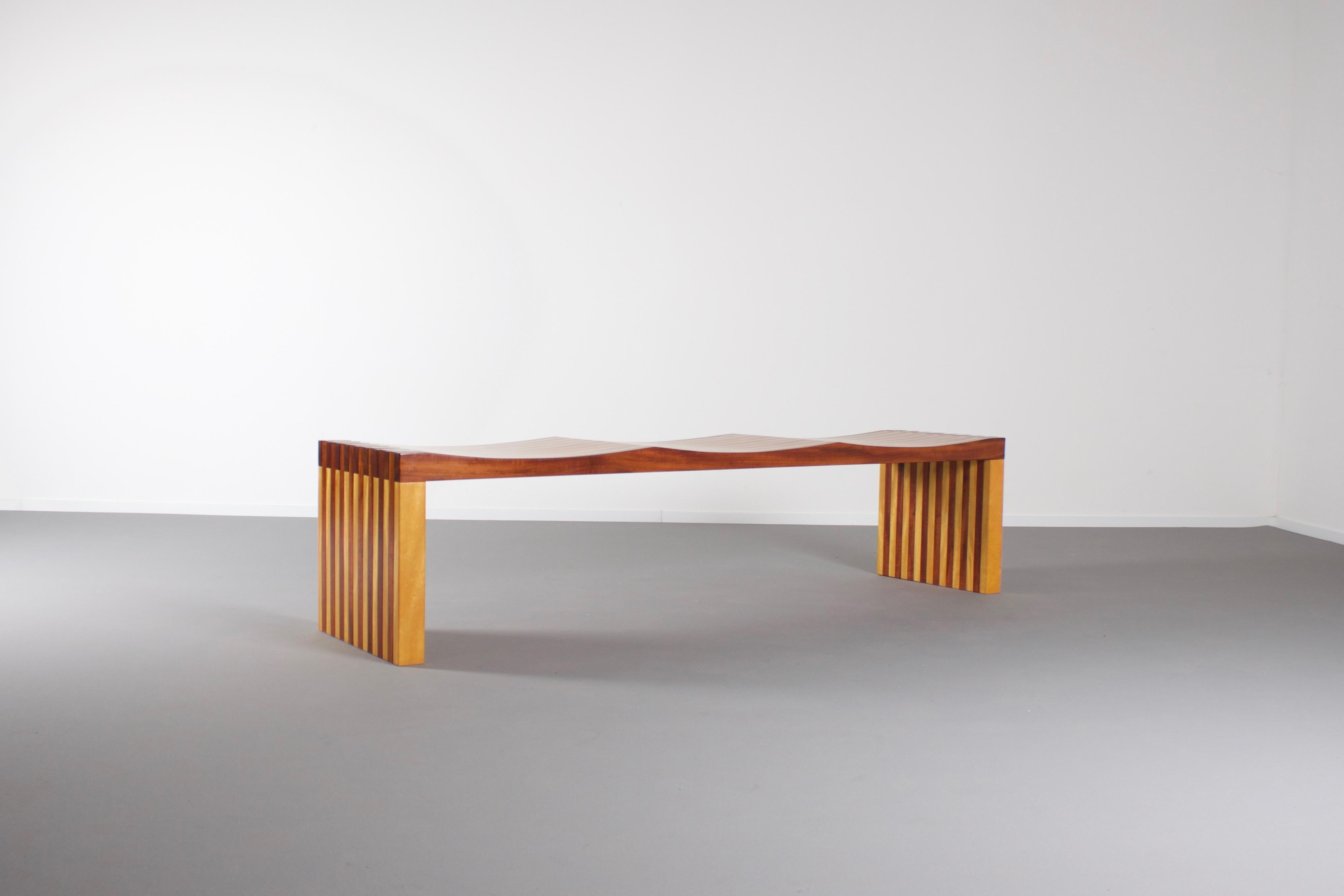 Exceptional ‘Ressaquinha’ bench in excellent condition.

Designed by the Brazilian architect Mauricio Azeredo.

This 3-seat bench is made of three different Brazilian woods: Cumaru, Muirapiranga and Pau-Ouro.

It is beautifully shaped and combines