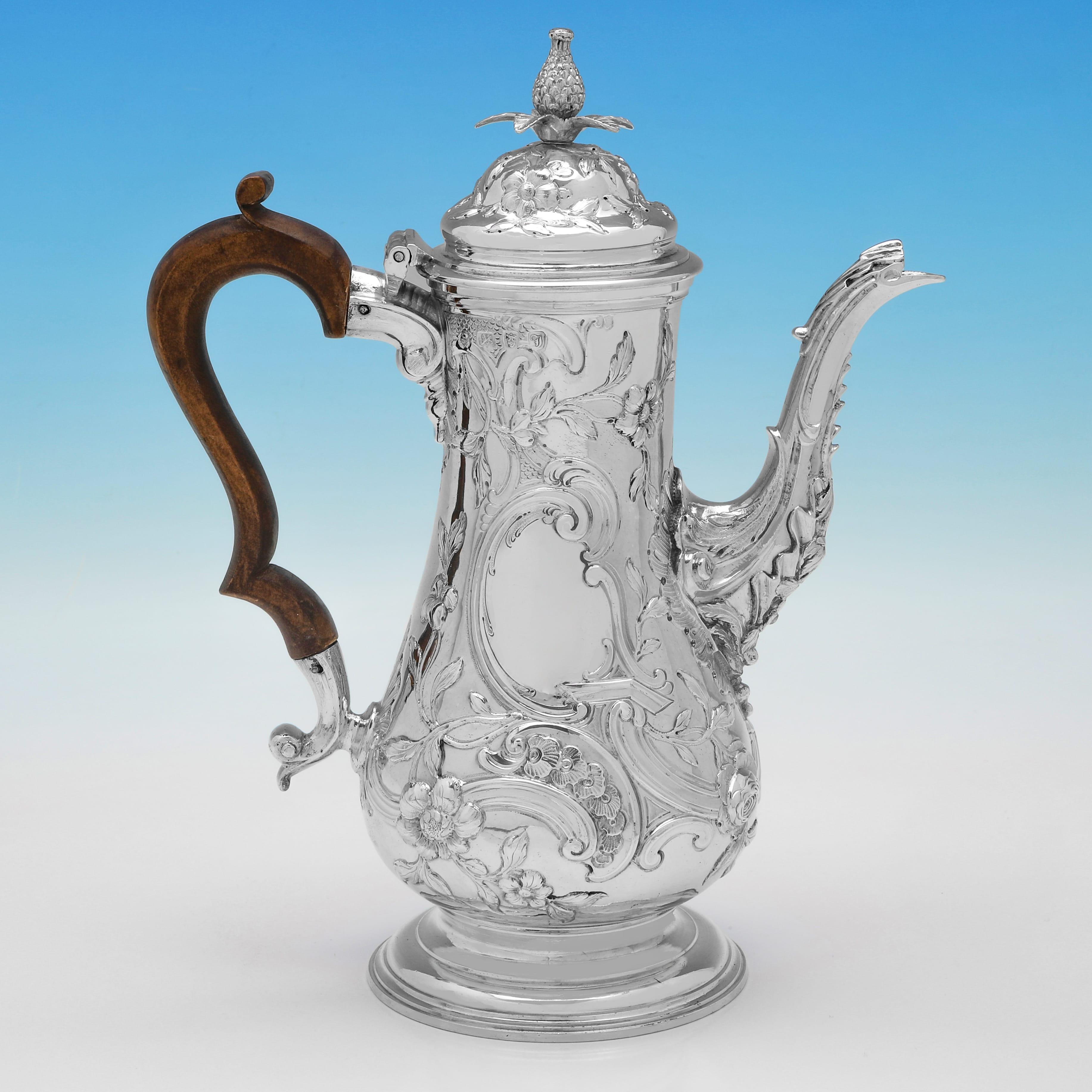 Hallmarked in London in 1764 by Thomas Whipham & Charles Wright, this exceptional, George III period, Antique Sterling Silver Coffee Pot, is in the Rococo taste, with ornate chased detailing throughout. 

The coffee pot measures 11