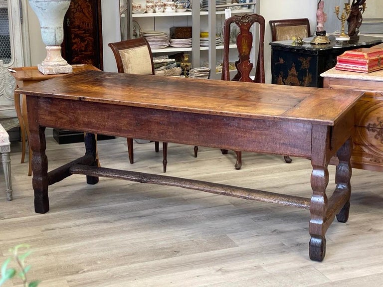 Exceptional 17th Century French Provincial Farm or Work Table, with a fine patina, the single-board top having deep breadboard ends over two long, heavy drawers supported by carved legs. Single Stretcher to base. Pegged construction with very early
