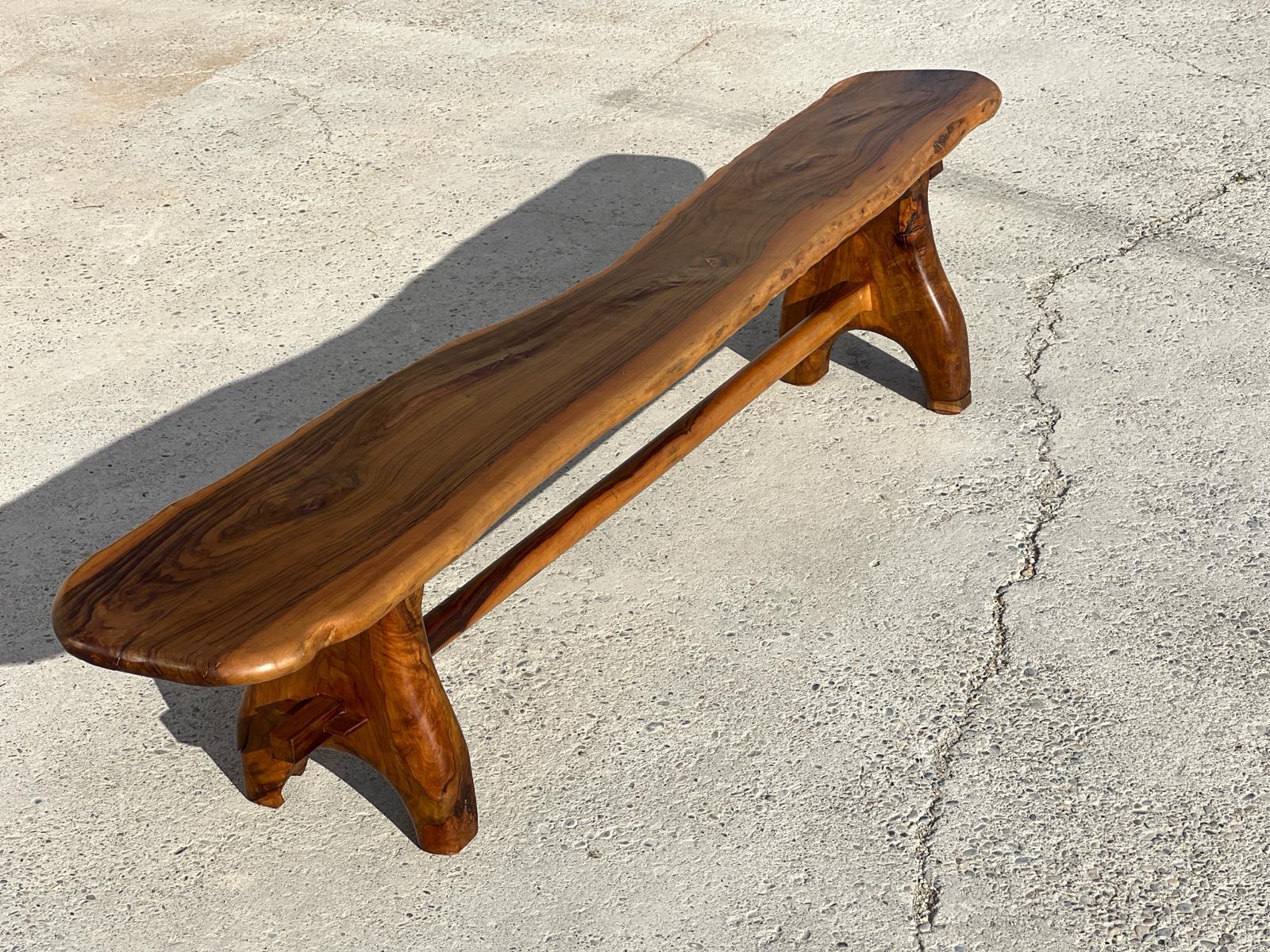 Exceptional, sculptural bench in solid olive wood, a French cabinetmaker from the Maison Skela 1960. 
The woodwork has been designed to respect the structure of the wood 
Width : 225 cm 
Excellent condition 