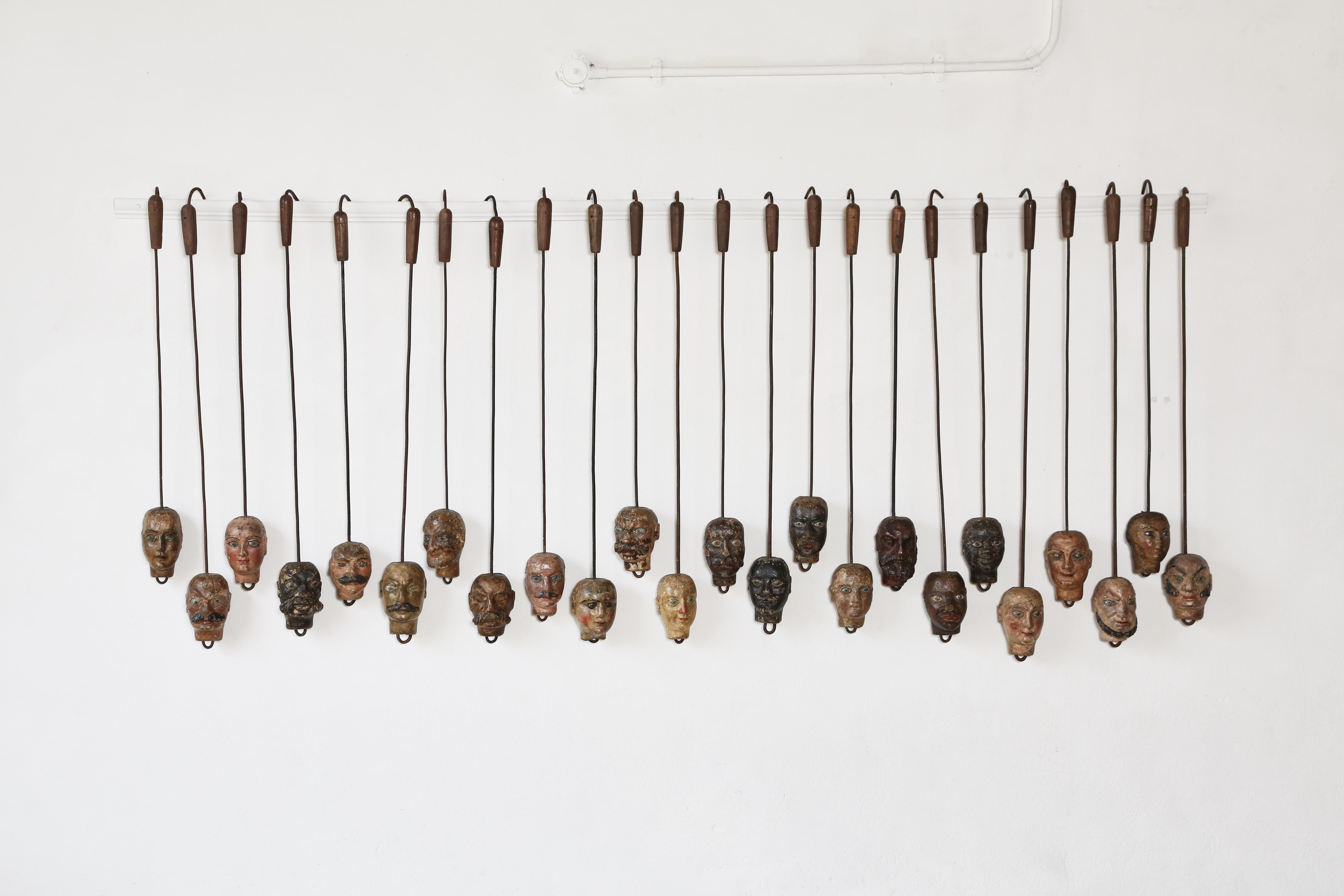 An extraordinary and exceptional museum-quality set of twenty four unique handcrafted Marionette puppet heads, Bergamo, Italy, 19th Century.    

Hanging height of between 85cm and 105cm.

The carved heads themselves are approximately 17x9cm.

Fast