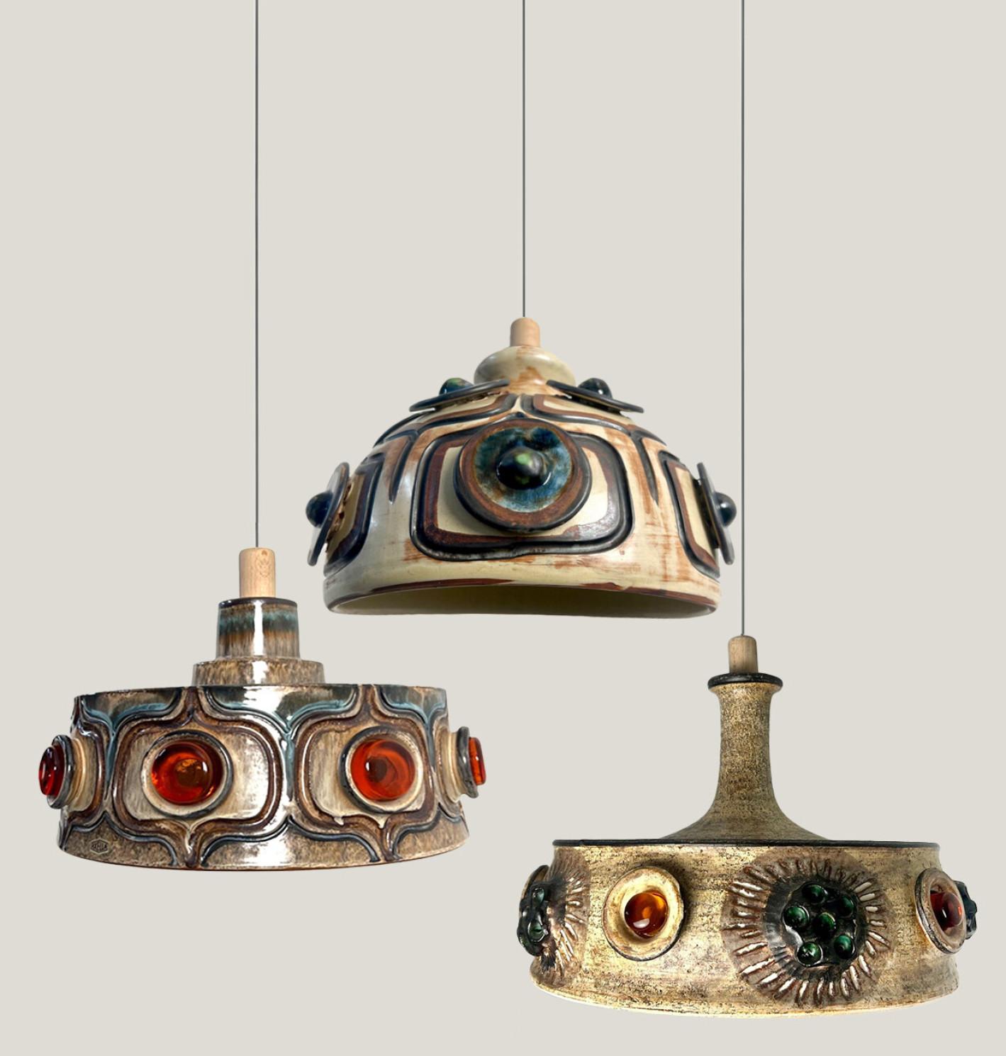 An exceptional  set of hanging lamps with an unusual shape, made with rich colored ceramic,  manufactured in the 1970s in Denmark.

With beautiful fragile steel cable and wooden details. Hanging on a steel cable the ceramic set is a real piece of