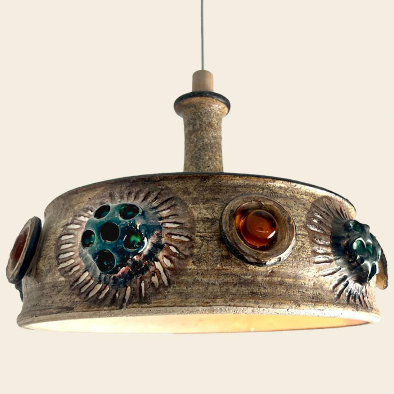 An exceptional  set of hanging lamps with an unusual shape, made with rich colored ceramic,  manufactured in the 1970s in Denmark.

With beautiful fragile steel cable and wooden details. Hanging on a steel cable the ceramic set is a real piece of