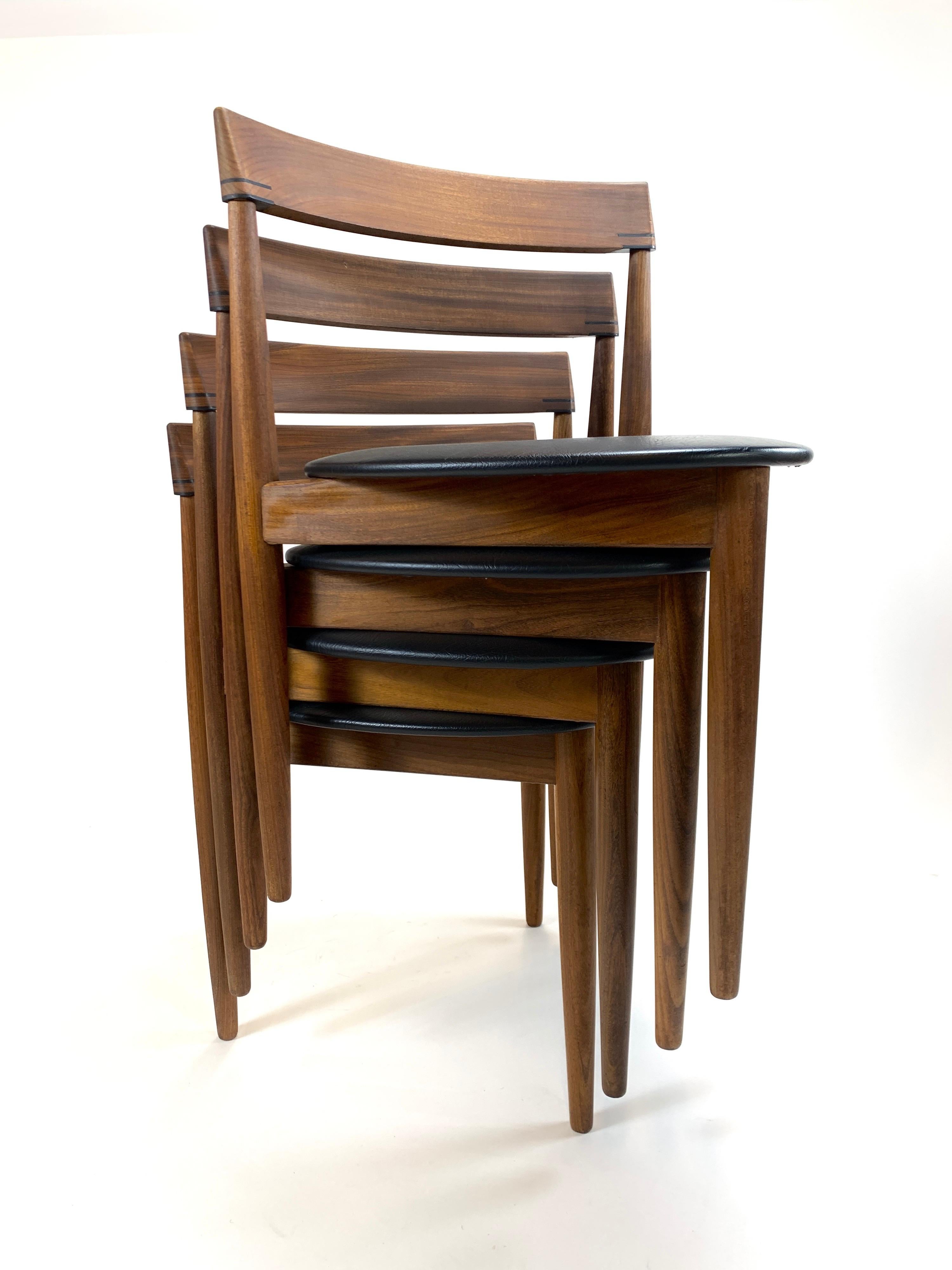 Designed and made in Denmark, these are a spectacular example of Mid-Century Modern, Danish design. Comfortable and stylish. Three tapered walnut legs leading to a triangular seat. Accented by linear joinery on the curved back, these are guaranteed