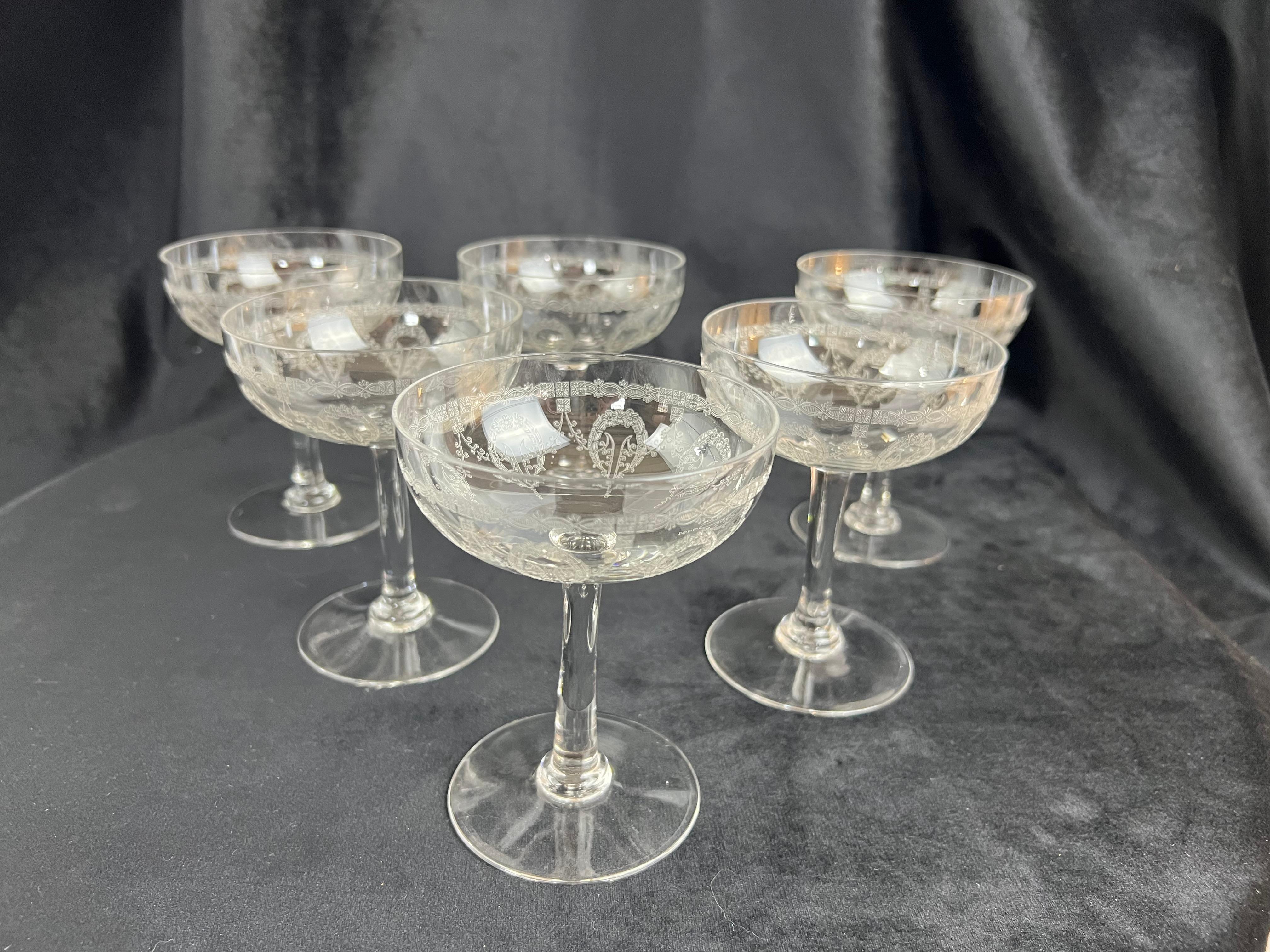 This rare set of 6 champagne coupes, crafted in blown and engraved crystal by the renowned Saint Louis crystal manufactory, dates back to the early 20th century. These exquisite pieces belong to the Noël service and feature the 