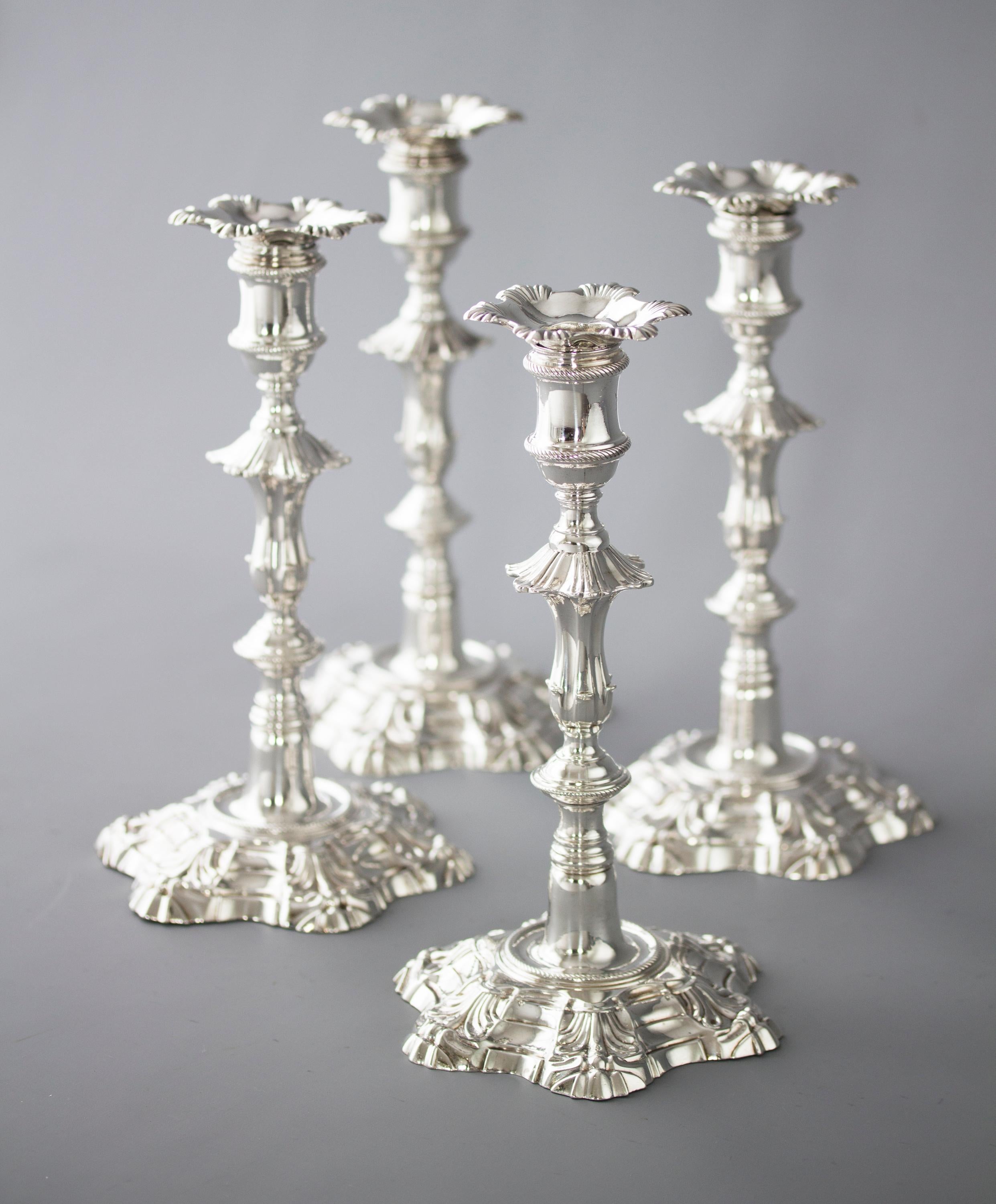 An extremely fine set of cast Silver candlesticks of petal form decoration rising from a stepped, hexagonal rope twist decorated base to a tapered fluted column beneath a hexagonal knop. The capitals of cotton reel form with rope twist decoration.