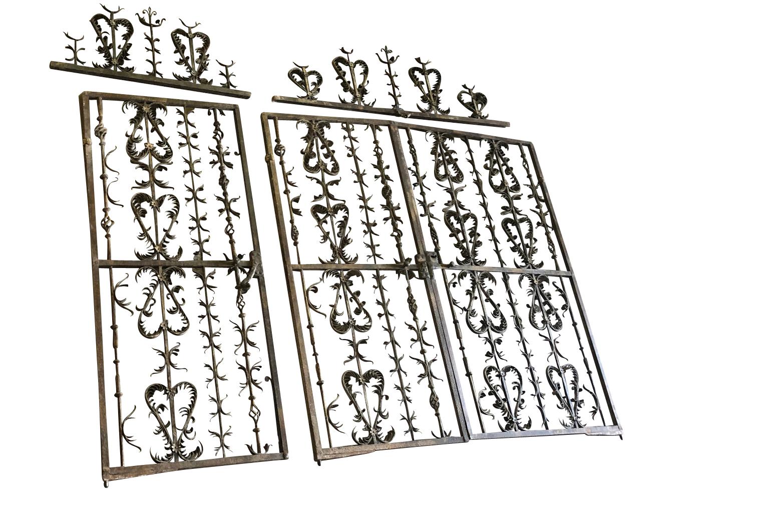 An exceptional and tremendous set of late 16th-early 17th century entry gates in hand forged iron. Exquisite craftsmanship. One segment measures 82 1/2