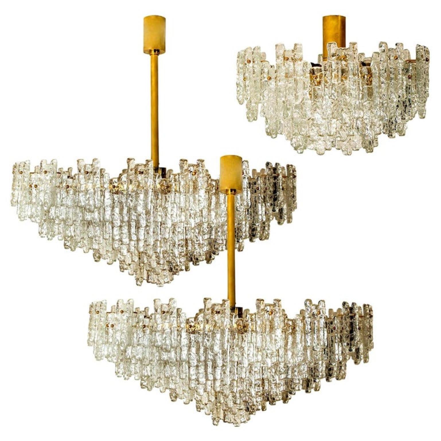 Set of exceptional, huge, clean and modern ballroom flush mount chandeliers by J.T. Kalmar Leuchten from the 1960s. The set consists layers with several hand blown textured glass shades mounted on a brass frame arranged in concentric rings.

This