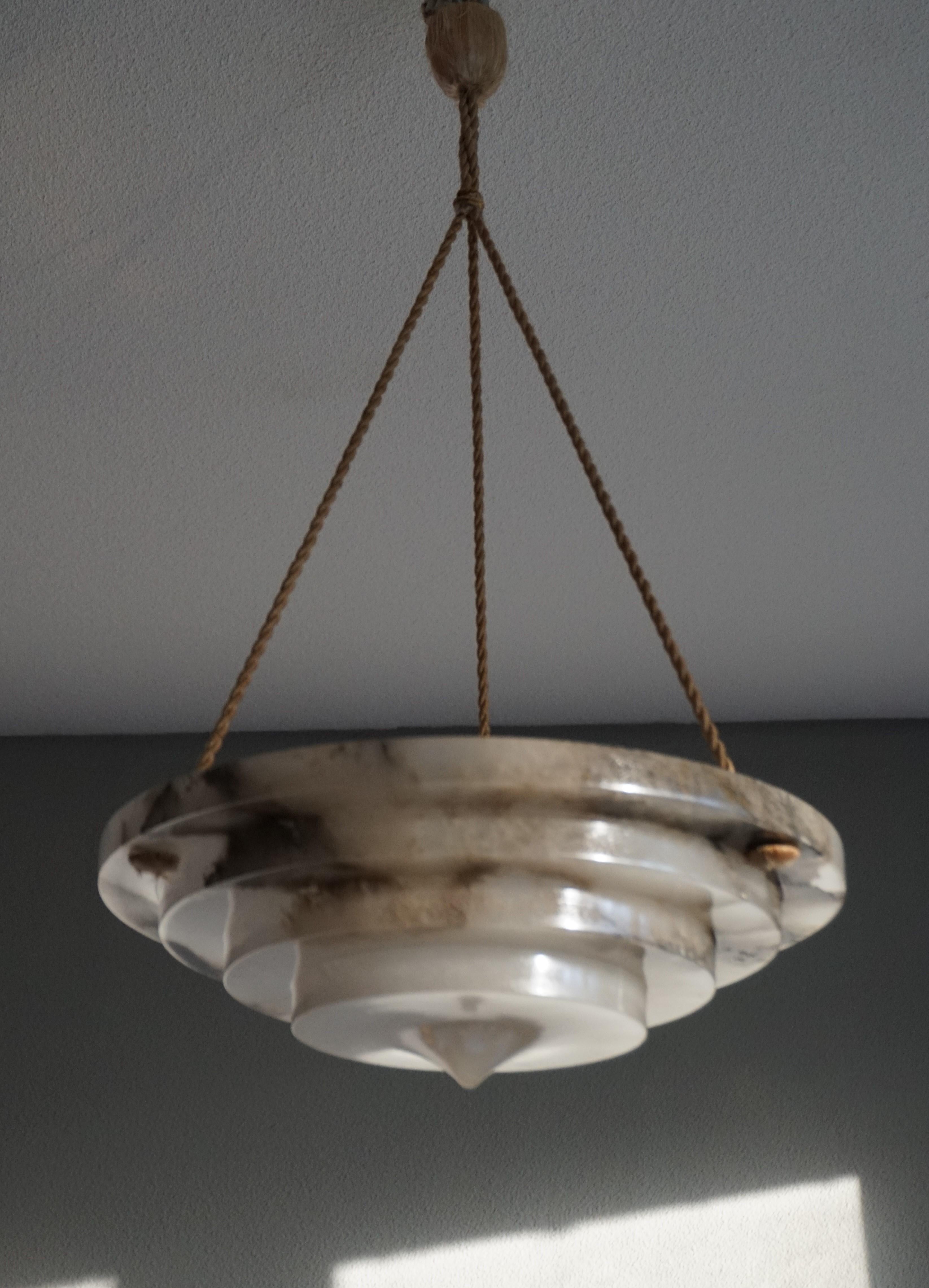 Stunning, geometrically circular Art Deco chandelier.

With early 20th century lighting as one of our specialties, we were thrilled to find another rare and truly beautiful Art Deco pendant, made of the most striking alabaster imaginable. The