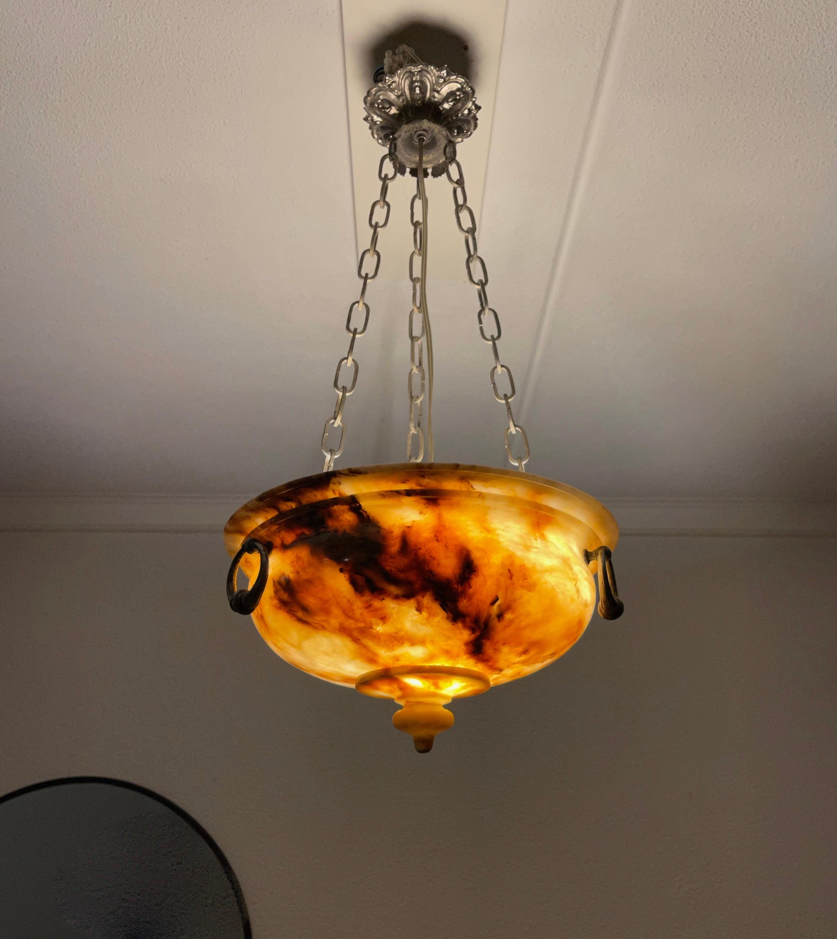 Small size, good quality and great value for money.

This early 1900s alabaster pendant comes with a perfect chain and stylish ceiling cap. The shape, the color and the effect of the multiple veins in this beautiful natural mineral stone make this