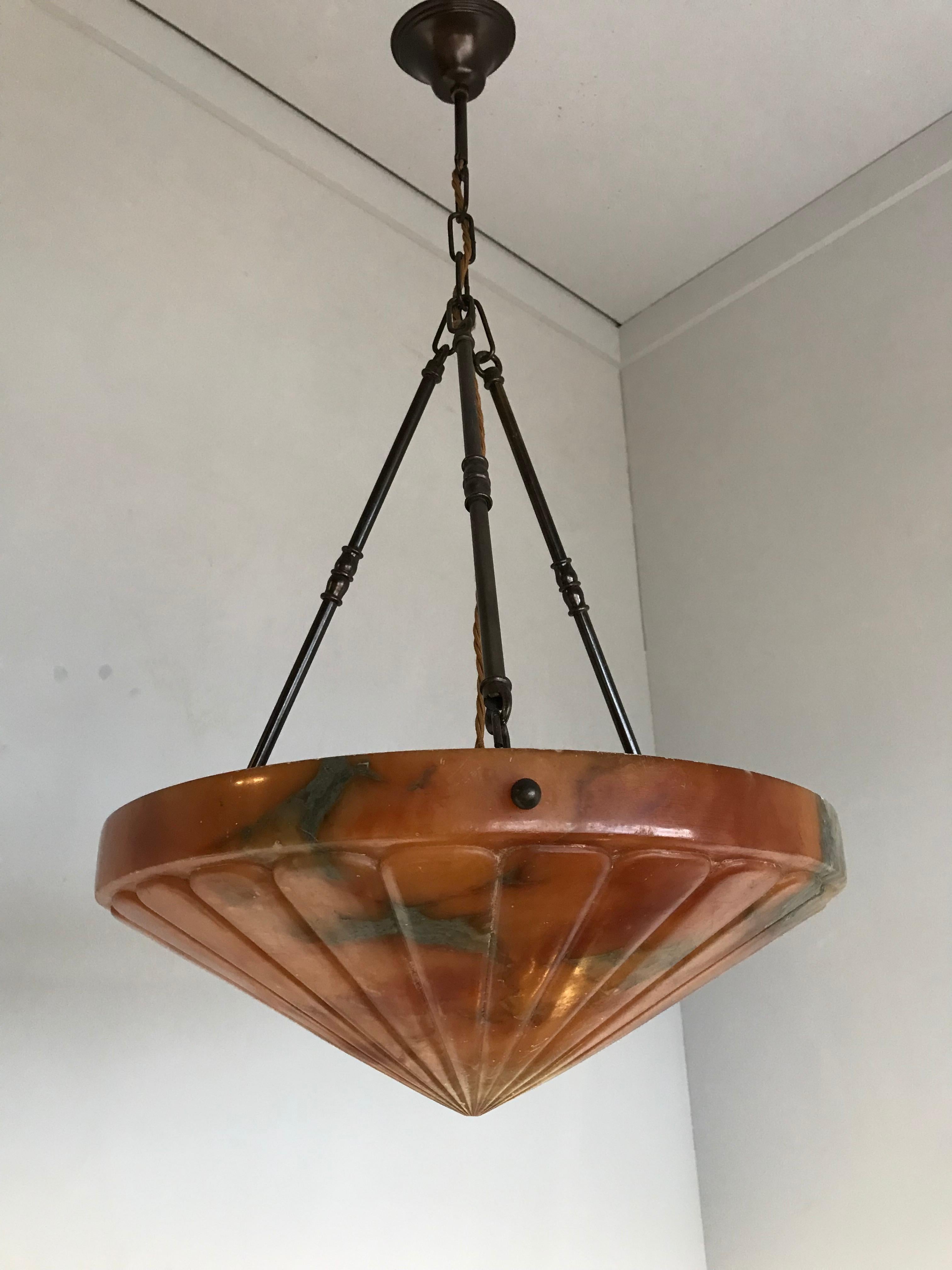 Stunning and geometrically designed, French Art Deco chandelier.

With early 20th century lighting as one of our specialties, we were thrilled to find another rare and truly beautiful Art Deco pendant, made of the most striking alabaster imaginable.