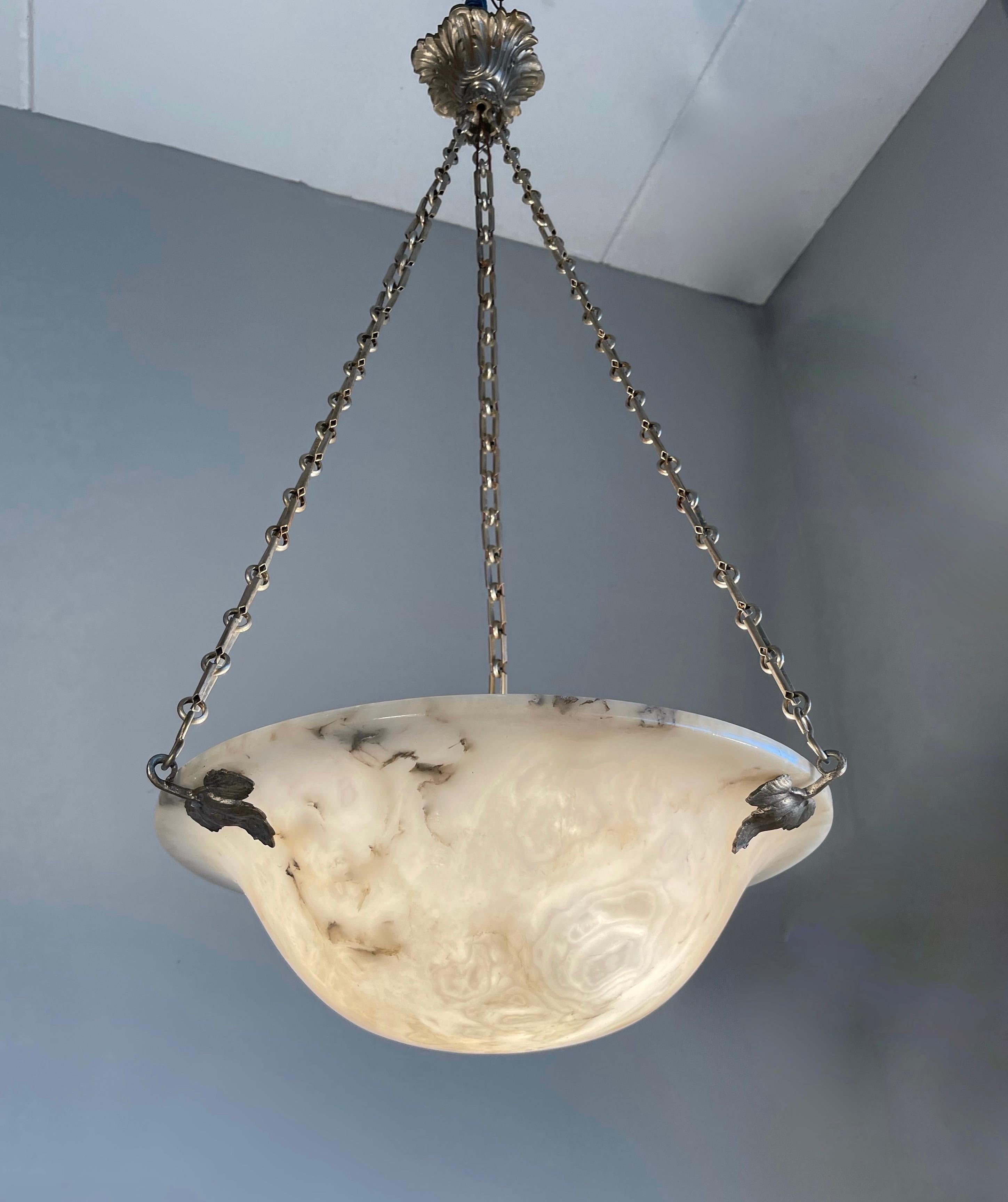 Stunning and good size French Art Deco chandelier in superb condition.

With early 20th century lighting as one of our specialities, we were again thrilled to find a unique Art Deco pendant made of the most striking alabaster stone. The timeless and