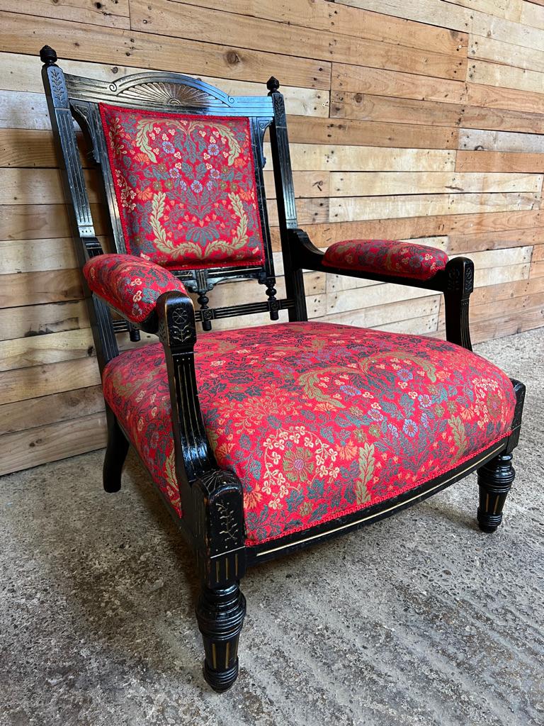 Exceptional shaped ebonised mahogany arm chair very unusual shape. upholstered in a bright coloured fabric, which is in very good condition, no marks.

Measurements seat height 37cm, back height 91cm, depth 80cm, width 68cm.