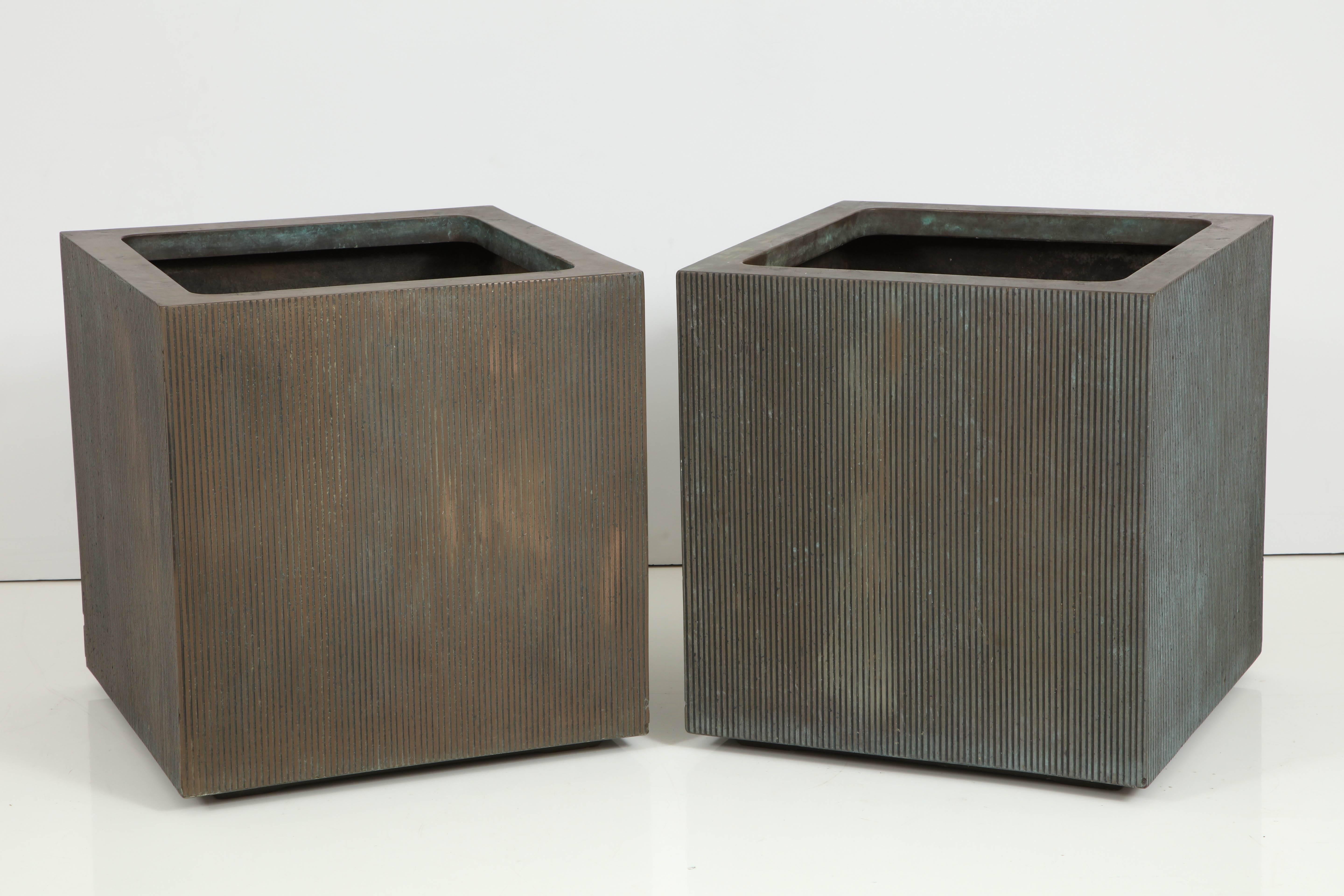 This exceptional pair of large 1970s square planters are by Forms and Surfaces, Santa Barbara CA.
The planters are beautifully executed of a heavy fiberglass resin material in a weathered Bronze color and they have a Brutalist design pattern to the
