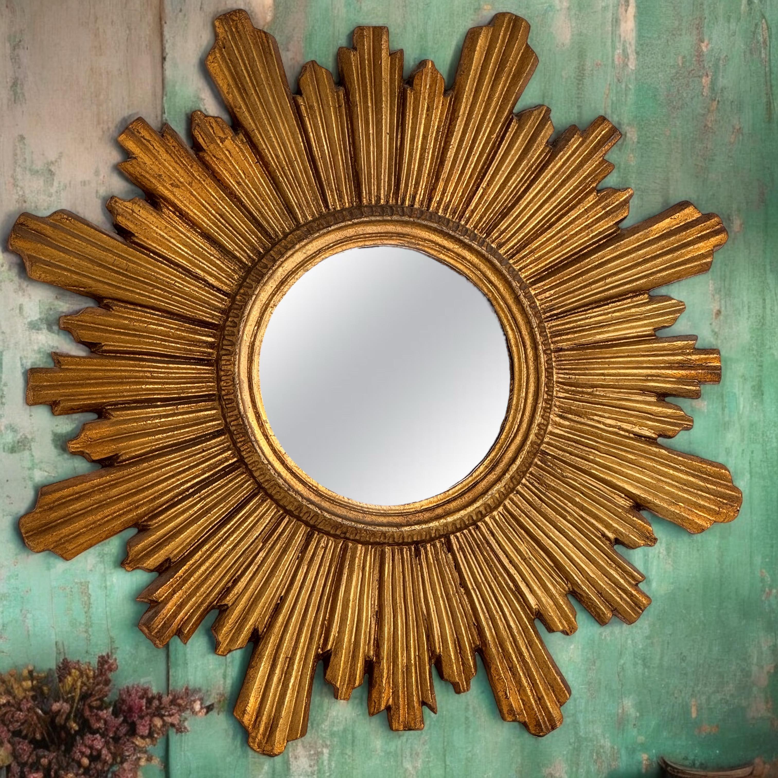 A gorgeous starburst sunburst flat mirror. Made of gilded wood. No chips, no cracks, no repairs. It measures approximate: 22.75