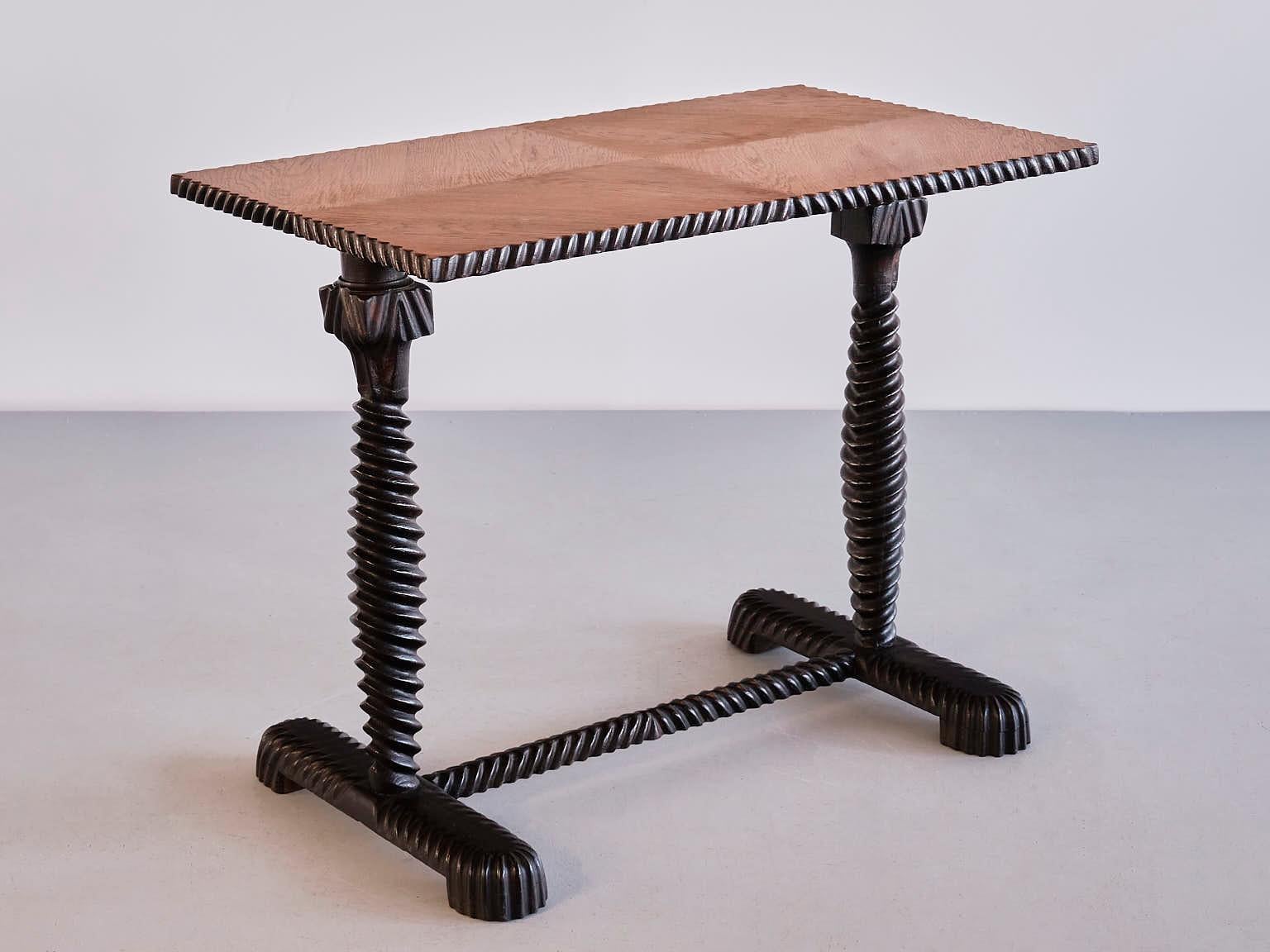 This exceptional rectangular side table was produced by a Swedish master cabinetmaker in the early 1930s. The design is marked by the refined, inctricately made lower frame in a dark stained oak wood. The entire frame and the sides of the top with