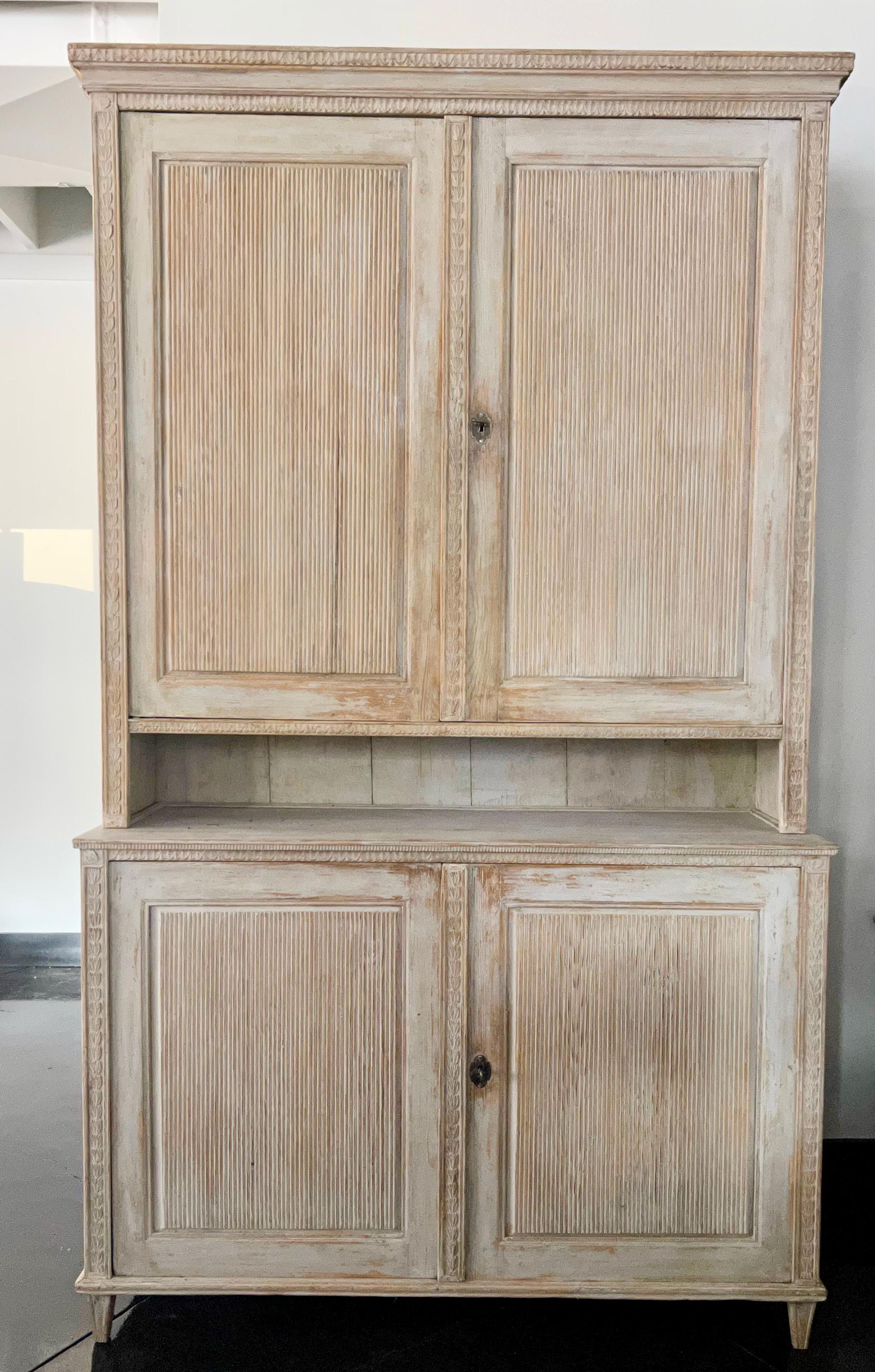 An exquisite carved and large period Swedish Gustavian cabinet, in two parts displays Classic Gustavian styling with reeded door panels in wonderful worn cream white patina. Very practical with plenty of storage.
Västerbotten, Sweden, circa