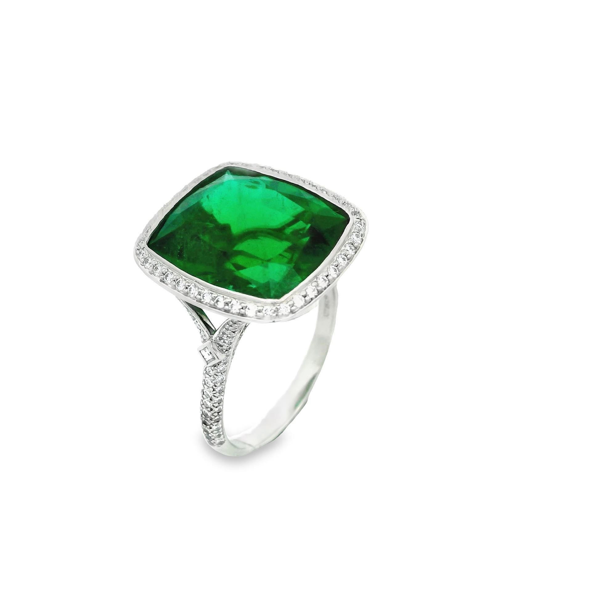 A simply amazing emerald ring by famed jewelers Tiffany & Co. The cushion-shaped gem emerald weighs 9.41 carats and has an intense vivid green color that rivals any other emerald you put in front of it. It is accented by 0.63 carats of fine round