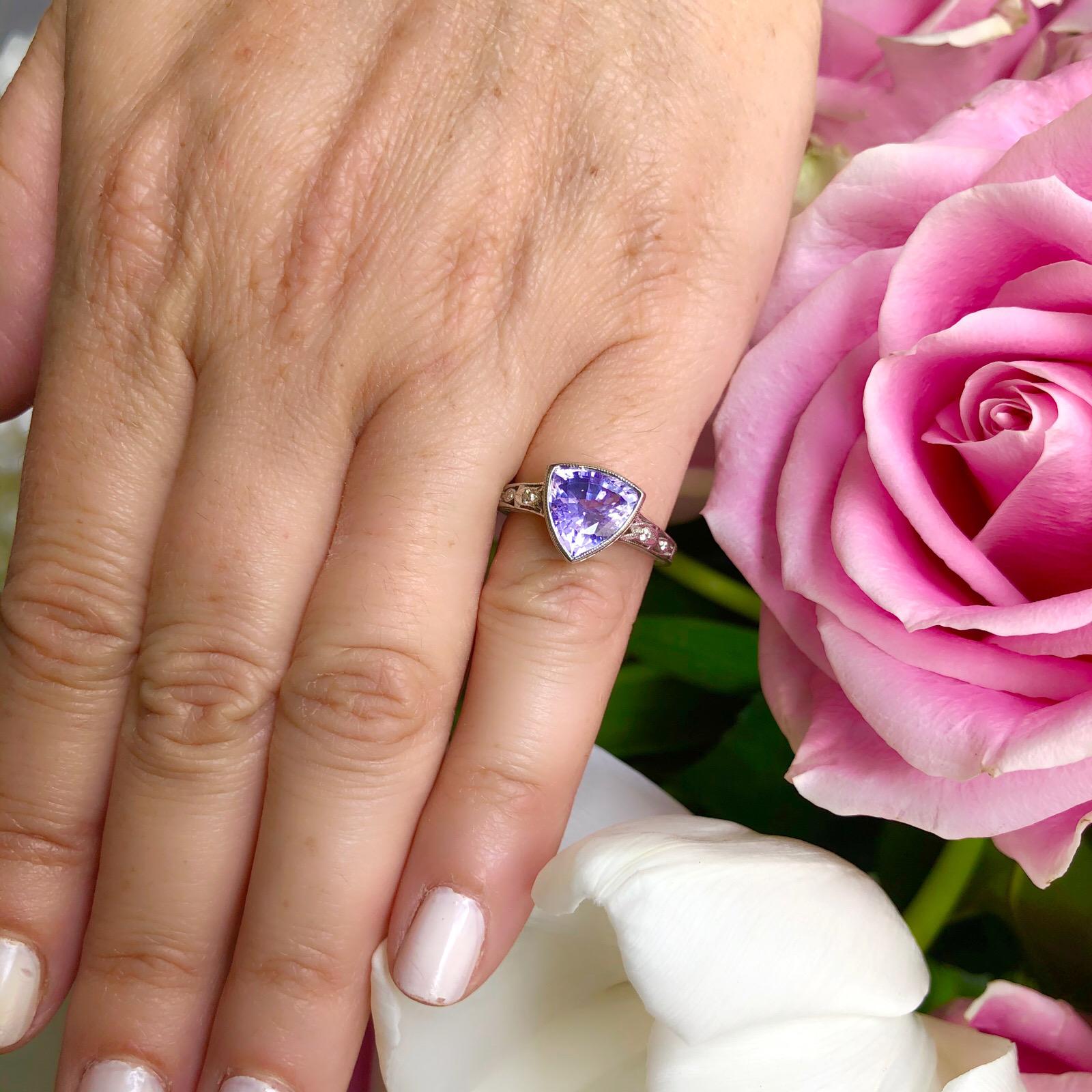 A gorgeous natural purple in a vintage inspired mounting sure to turn heads. Singular triangular-cut unheated bluish violet sapphire weighing 3.38cts, a beautiful and lively light violet color with great saturation that captures your eye and