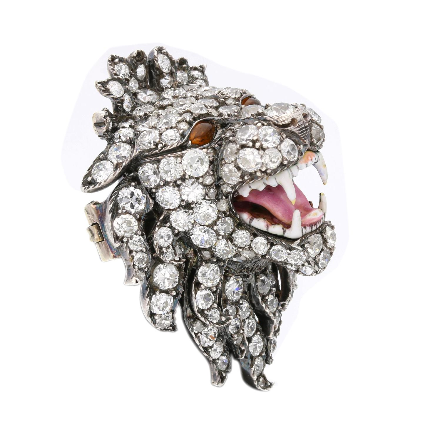 A sensational Victorian diamond and enamel brooch c.1890, modelled as a three dimensional roaring lion head with magnificent mane set throughout with old brilliant cut diamonds, with open mouth baring white enamel teeth and pink enamel tongue and