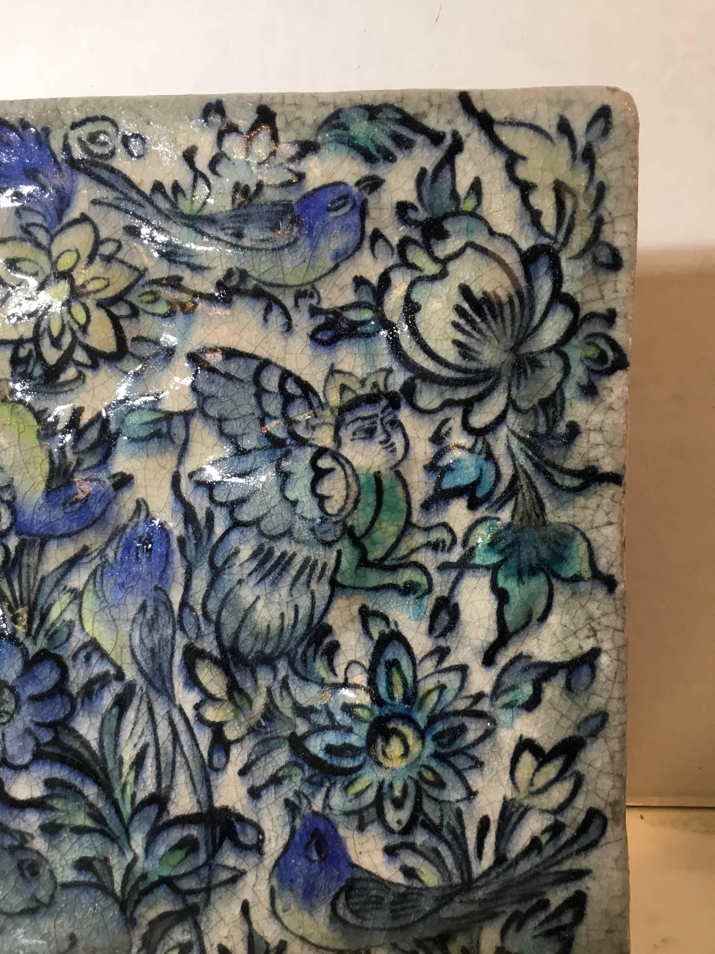 Exceptional Persian tile hand-painted and glazed with beautiful scenery of birds flying between vines and flowers, on the left bottom there is animal resting ,and in the middle of the tile there is like flying
Motif from Persian mythology that look