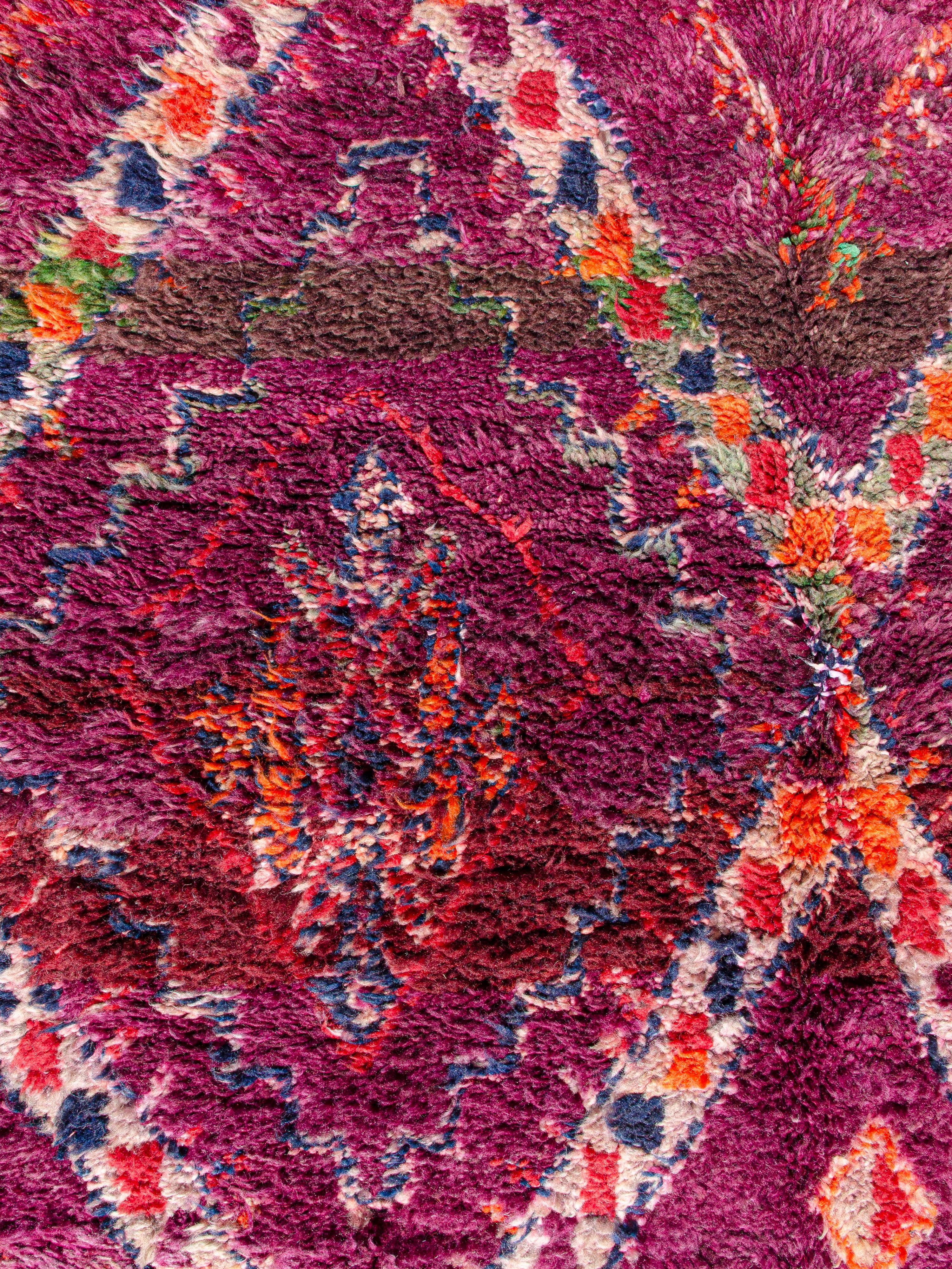 An exceptional vintage Moroccan Beni M'Tir with a network of large scale lozenges containing smaller lozenges and Berber symbolism within. Male protection vertical chevron borders run along both selvedges. Palette includes an abrashed ground of