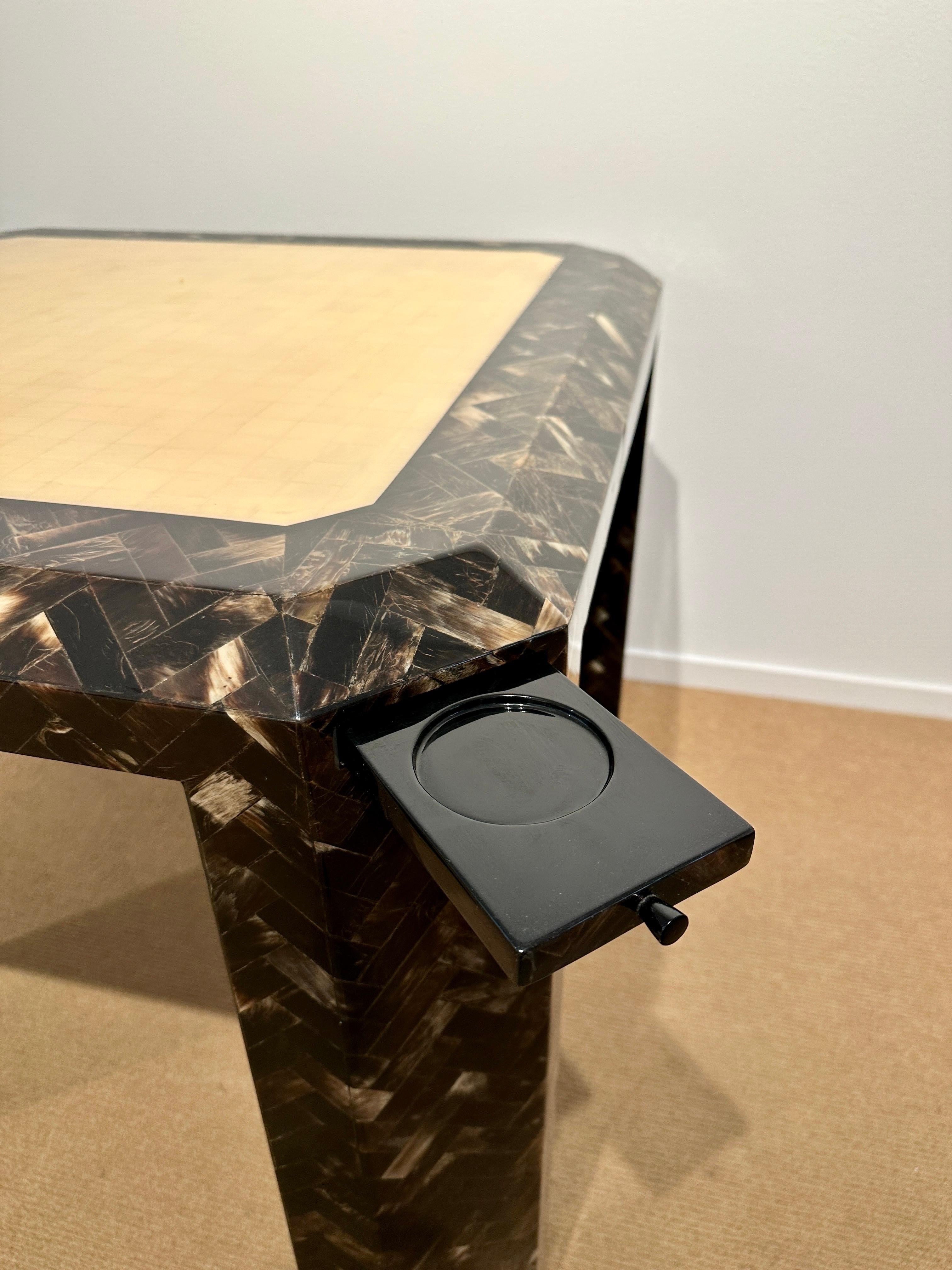 SIGNED Enrique Garcel to underside, this unique game table in two tones of born and horn veneer. Pull out drinks shelves on all four corners are wonderful and whimsical feature. Wonderful vintage condition. The table is hand made in Colombia. The