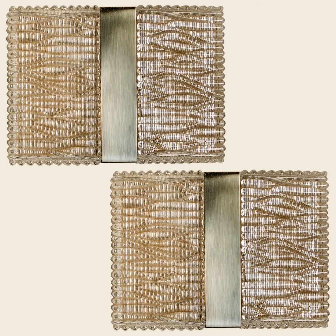 Wonderful stylish textured glass wall lights from Limburg Glashütte produced in Germany, Europe in the 1970s.
The lights are rectangular shaped and made of textured glass with a chrome center.

In good vintage condition. Good. Lightly used, with