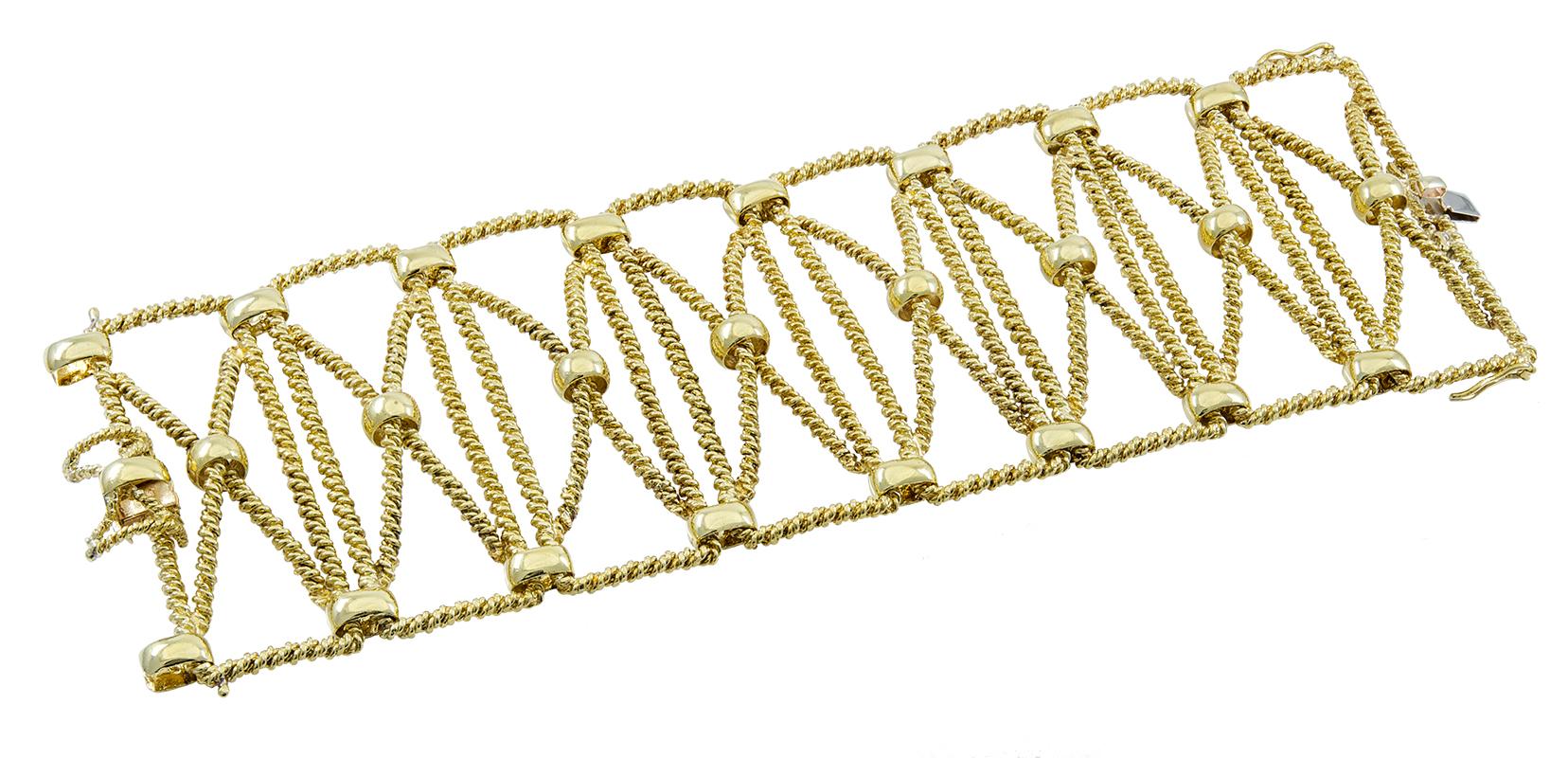 Extra-wide flexible bracelet.  Made and signed by TIFFANY & CO.  Heavy gauge 18K yellow gold.  Rope-twist  textured links, set with shiny gold balls.  7