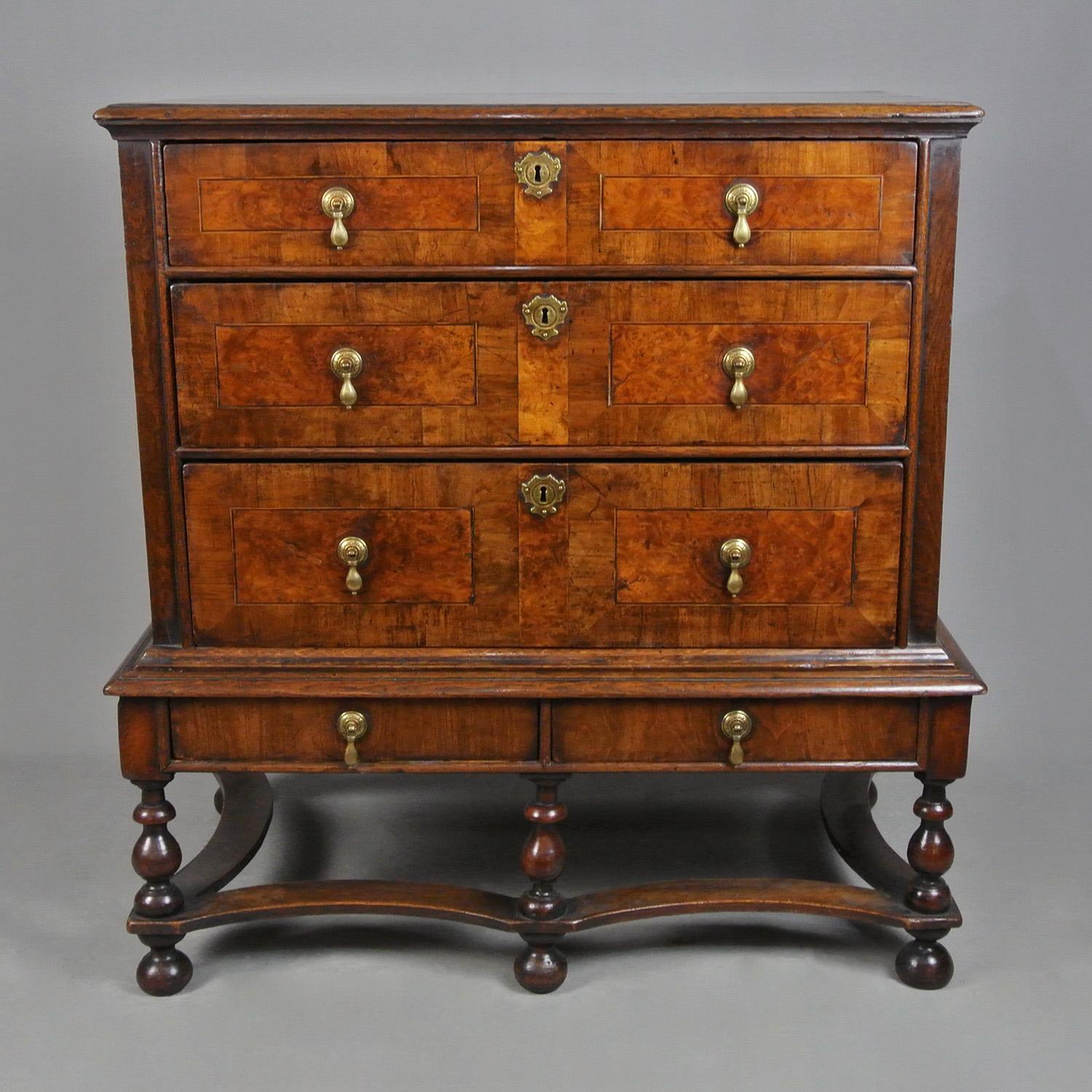 A truly wonderful William and Mary Oak and Walnut chest on original stand, completely original including brass drop handles, engraved back plates, locks and escutcheons.   

Of a small size, perfectly proportioned, and with a fantastic colour and