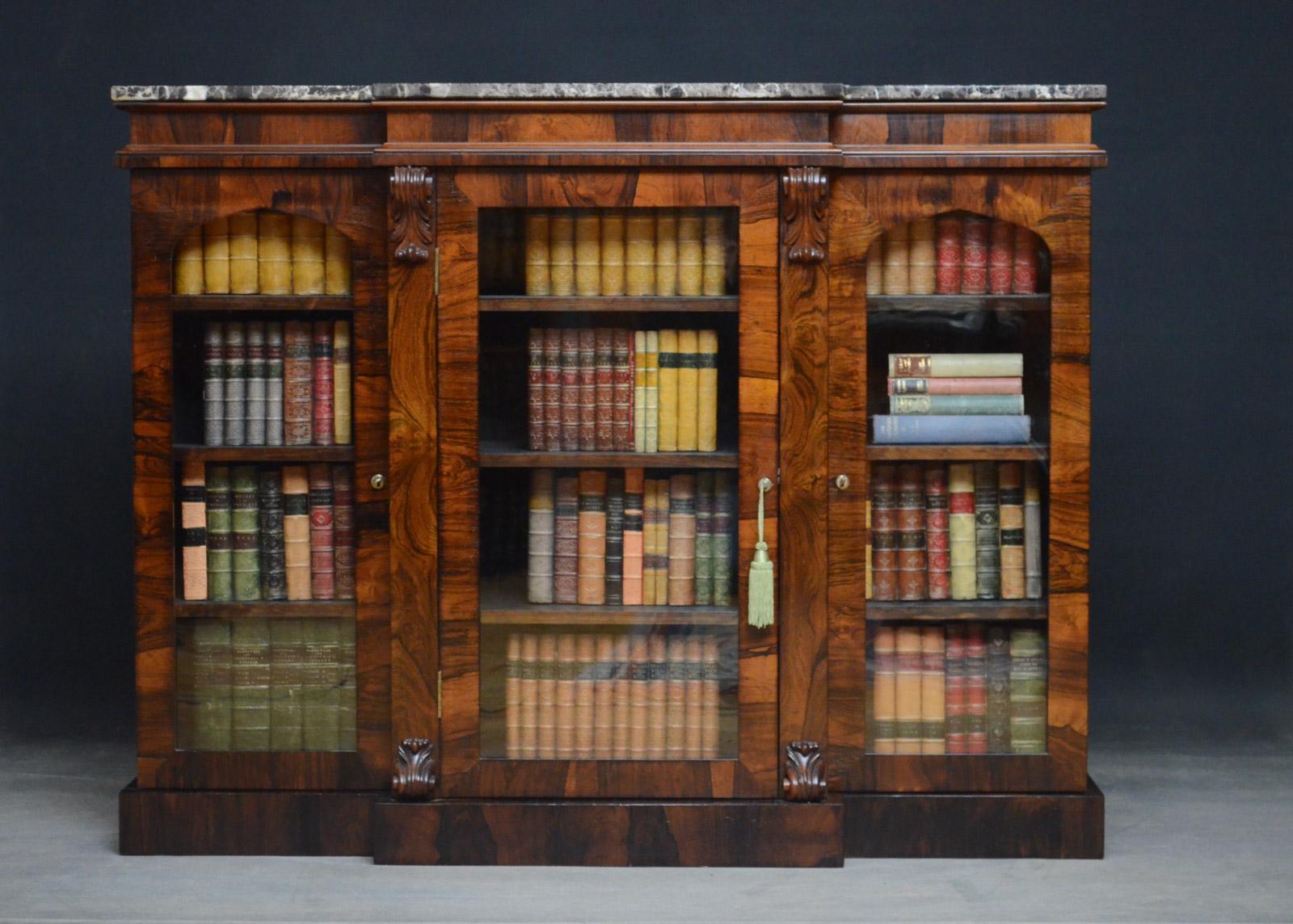 Sn4585, fine quality William IV glazed bookcase of breakfronted design, having marble top above a moulded frieze and a glazed door enclosing 3 height adjustable shelves, all flanked by drop carvings and further glazed door enclosing adjustable