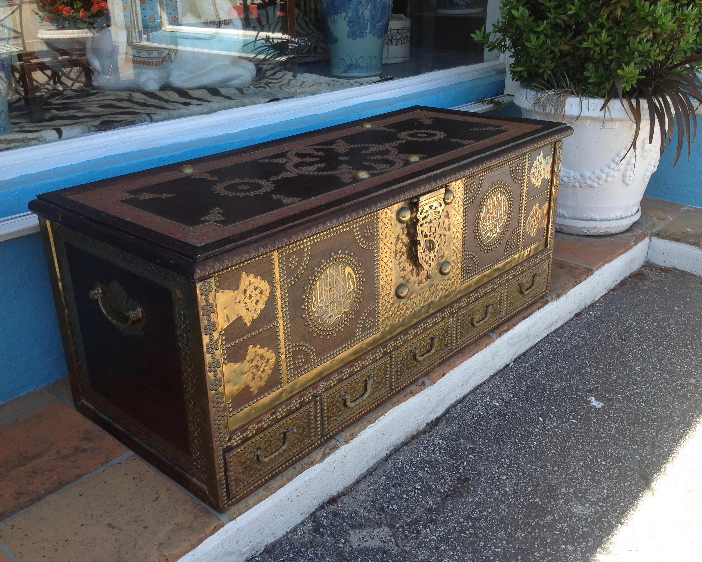 Ideally scaled as a coffee table with extensive brass overlays
The piece is designed with five bottom drawers.
The 