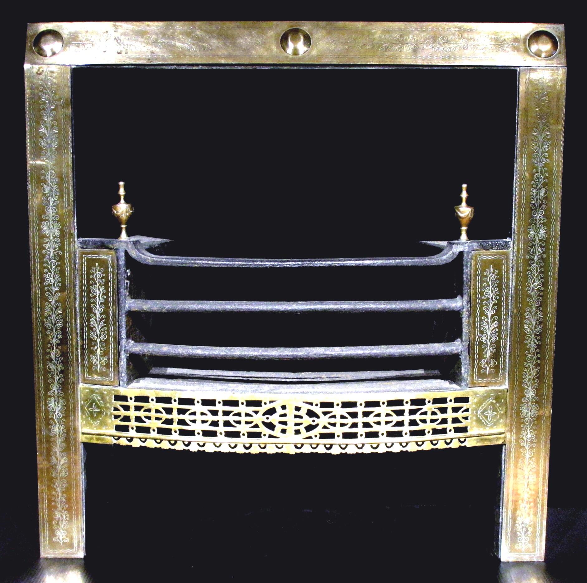 A very handsome 18th century Georgian Irish fire grate / register, showing a brass surround engraved with neoclassical motifs, framing an iron basket with a triple bar grate, flanked on either side by similarly engraved brass-panelled fire cheeks