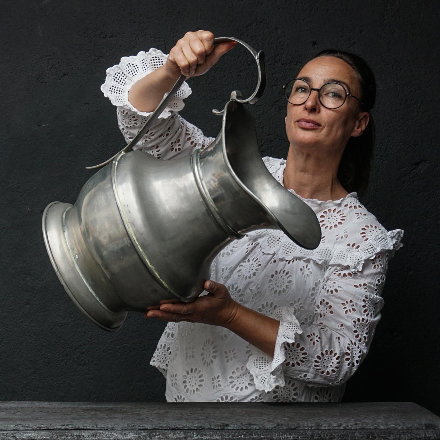 Very decorative exceptionally large and heavy 19th century tin baptismal water jug, pitcher or jug
Marked on the bottom 92.5% tin.

This looks fabulous as vase for an impressive bouquet of flowers.
   