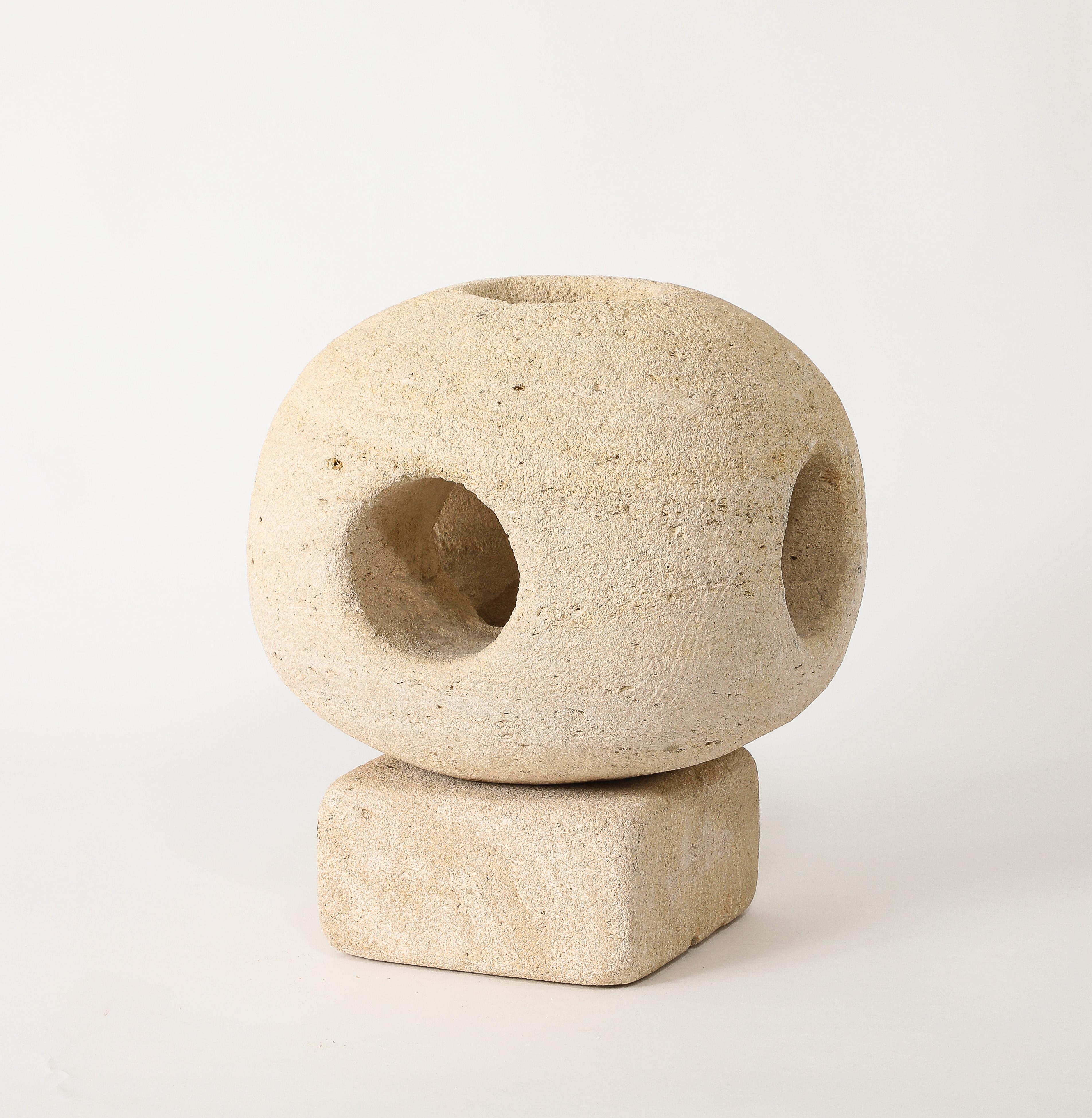 Solid carved Pierre du Gard table lamp in a spherical shape with holes letting the light through. Amazing scale
