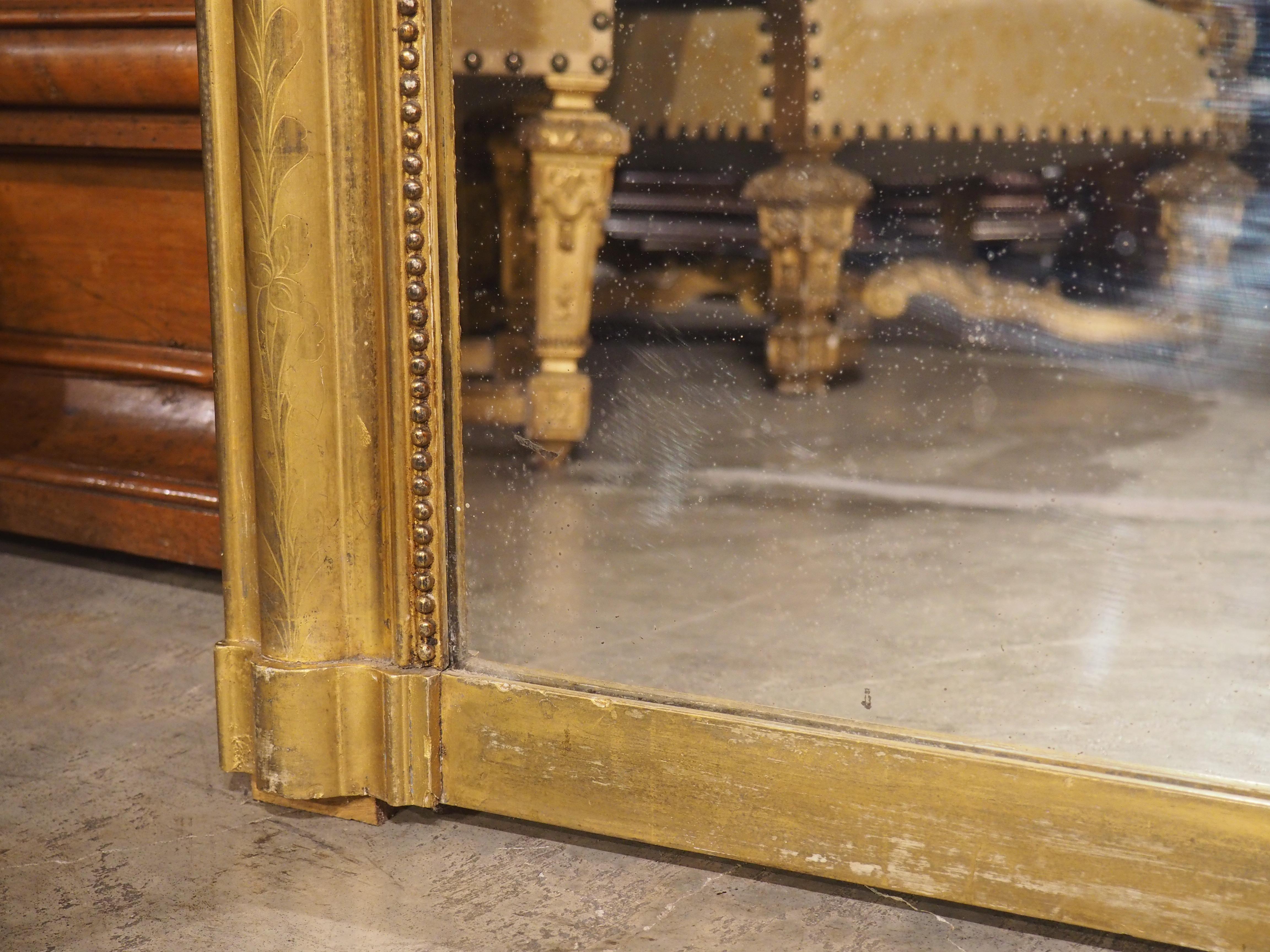 Louis Philippe mirrors are known for their rounded top corners and subtle embellishments to the frame. In the 19th century, these types of mirrors were often placed above fireplace mantels in apartments throughout Paris. Due to its size, our French